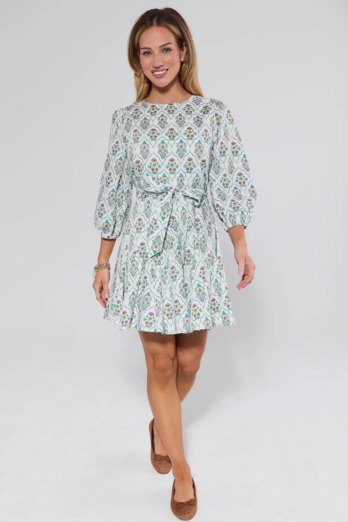 Woman wearing a floral dress on a white background