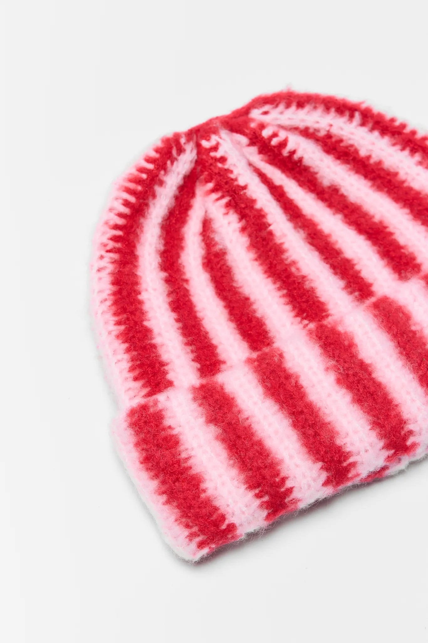 Red and white striped knit hat on a light gray background Tatum Red Striped Knit Beanie