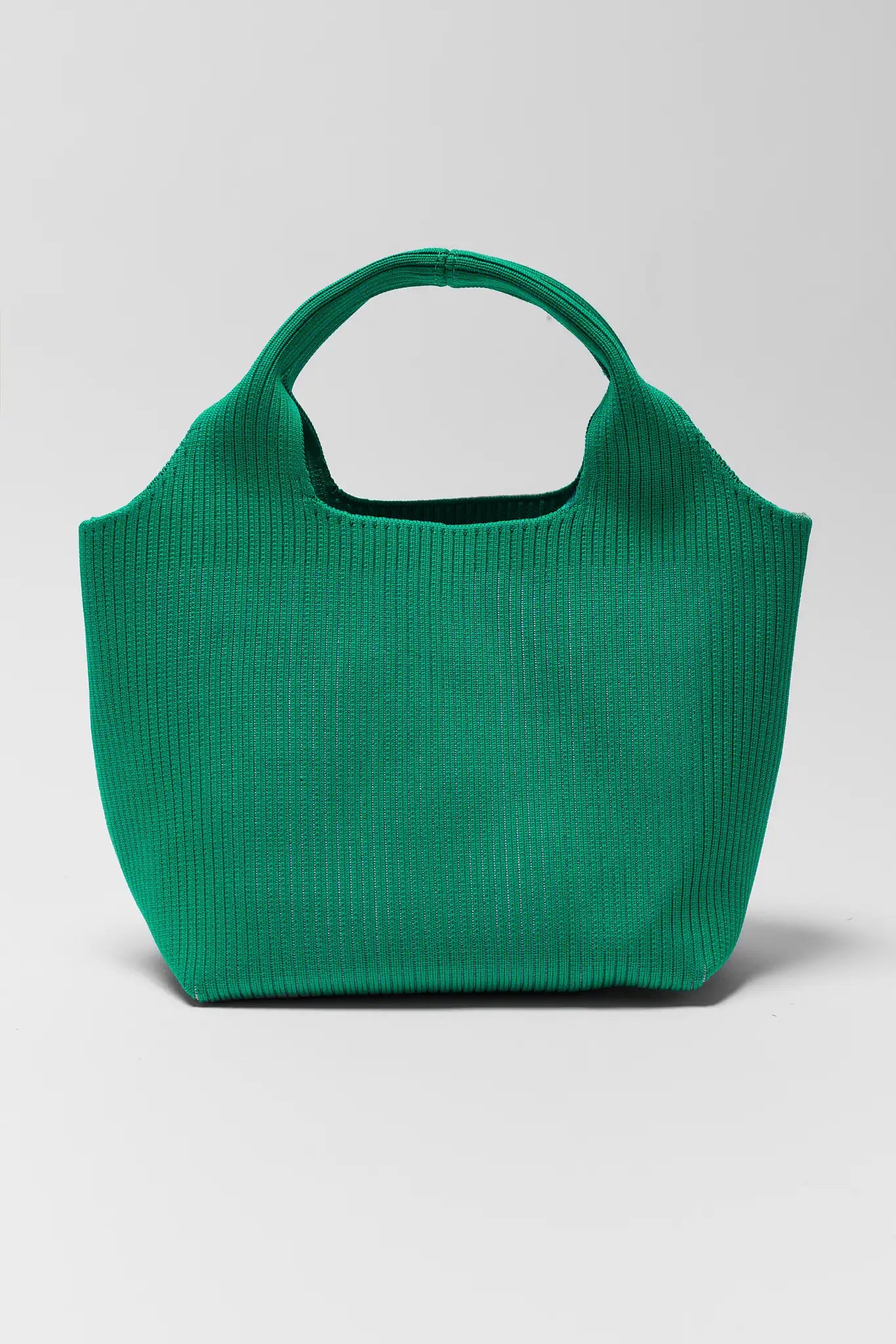Green handbag on a light gray background