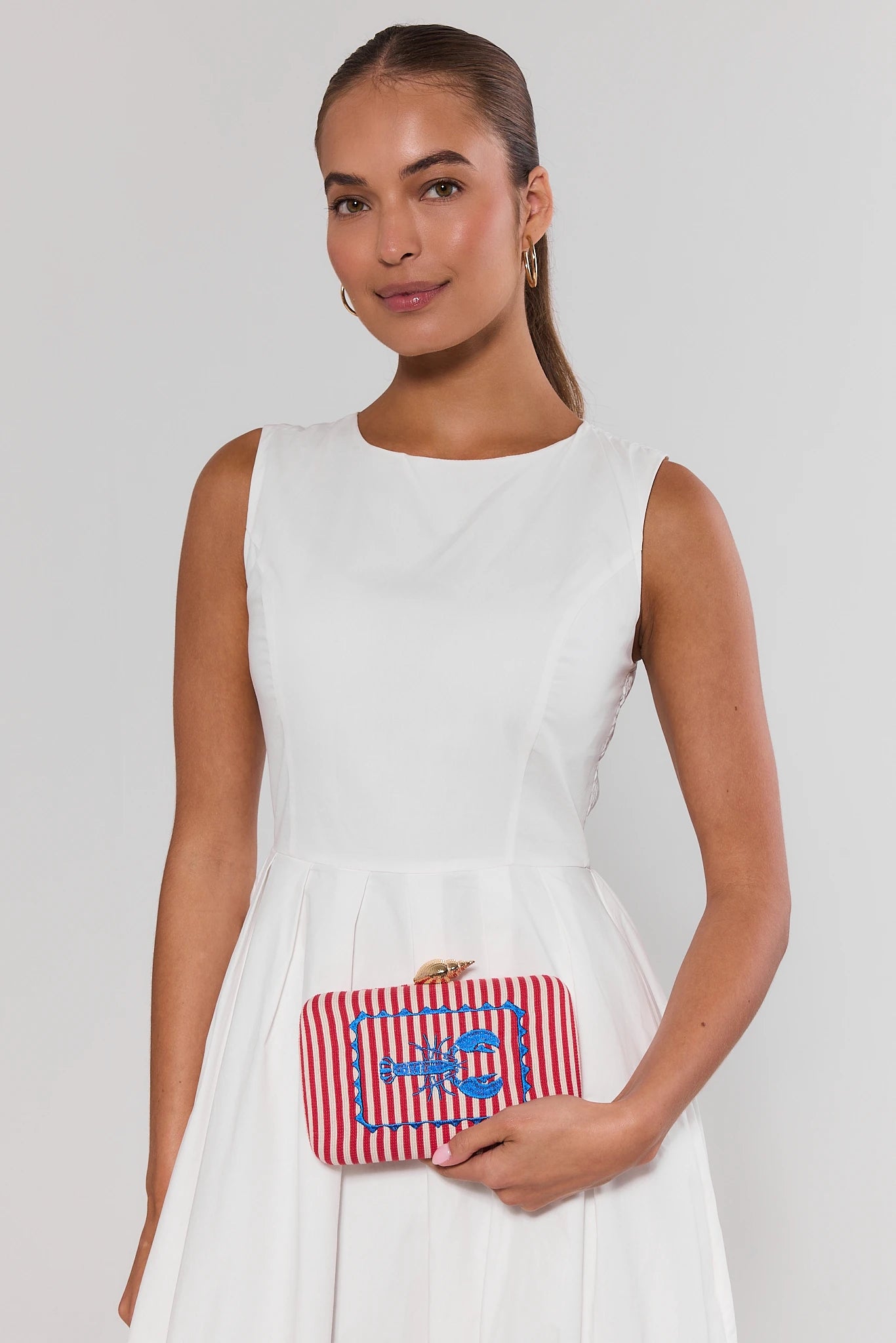 woman holding marina clutch