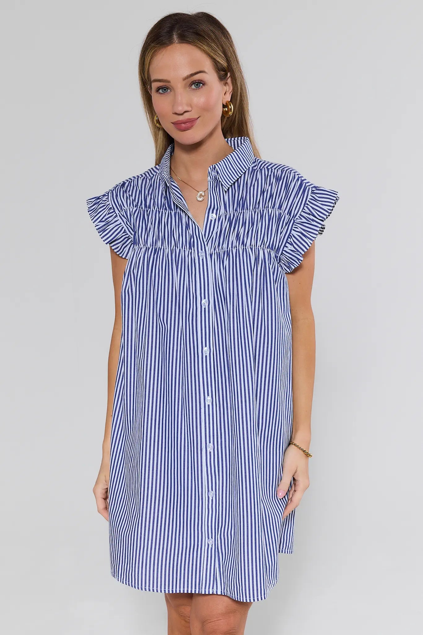 woman wearing blue and white stripe dress