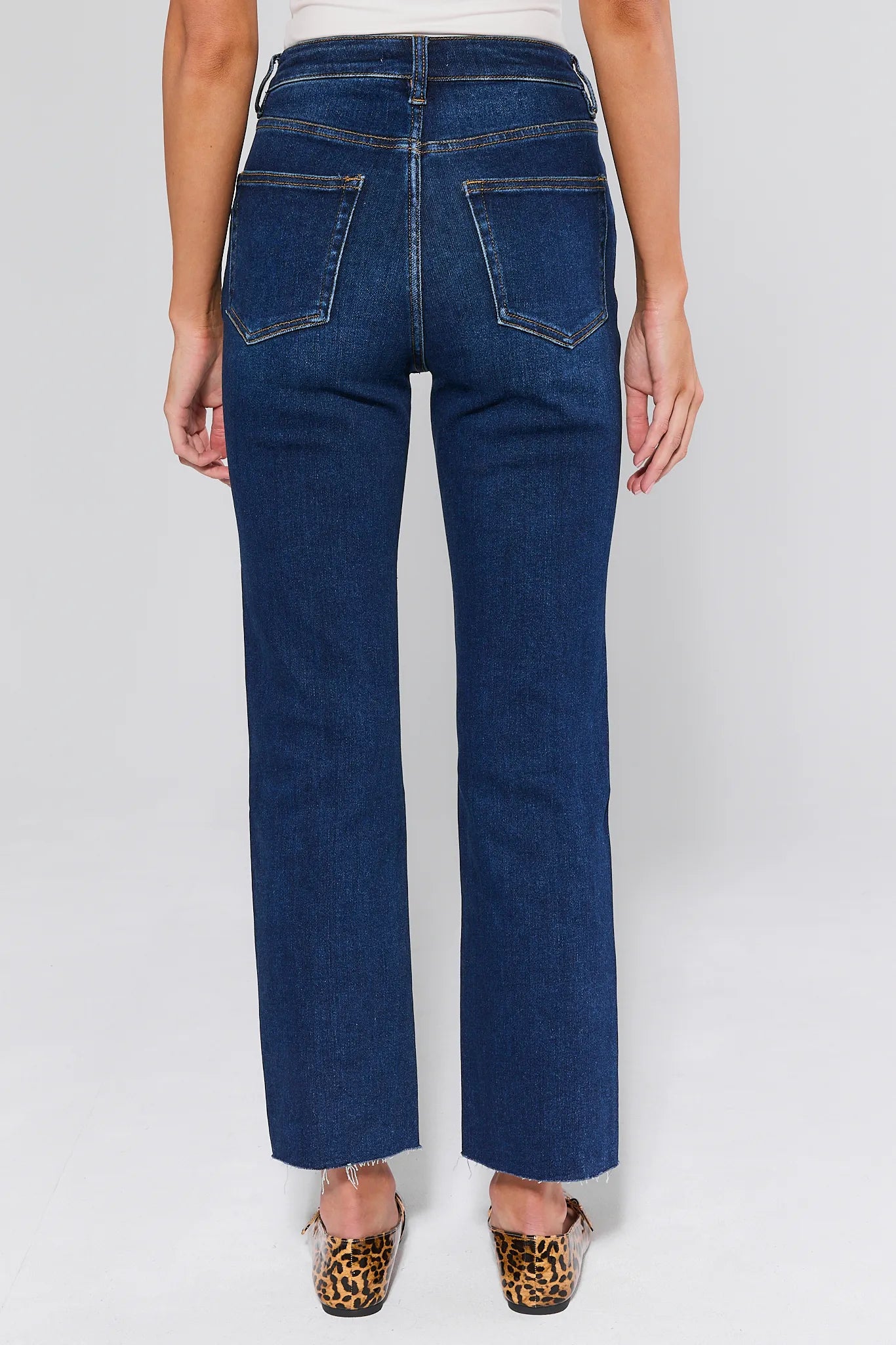 Person wearing Lucy Dark Wash Straight Leg Jeans on a white background