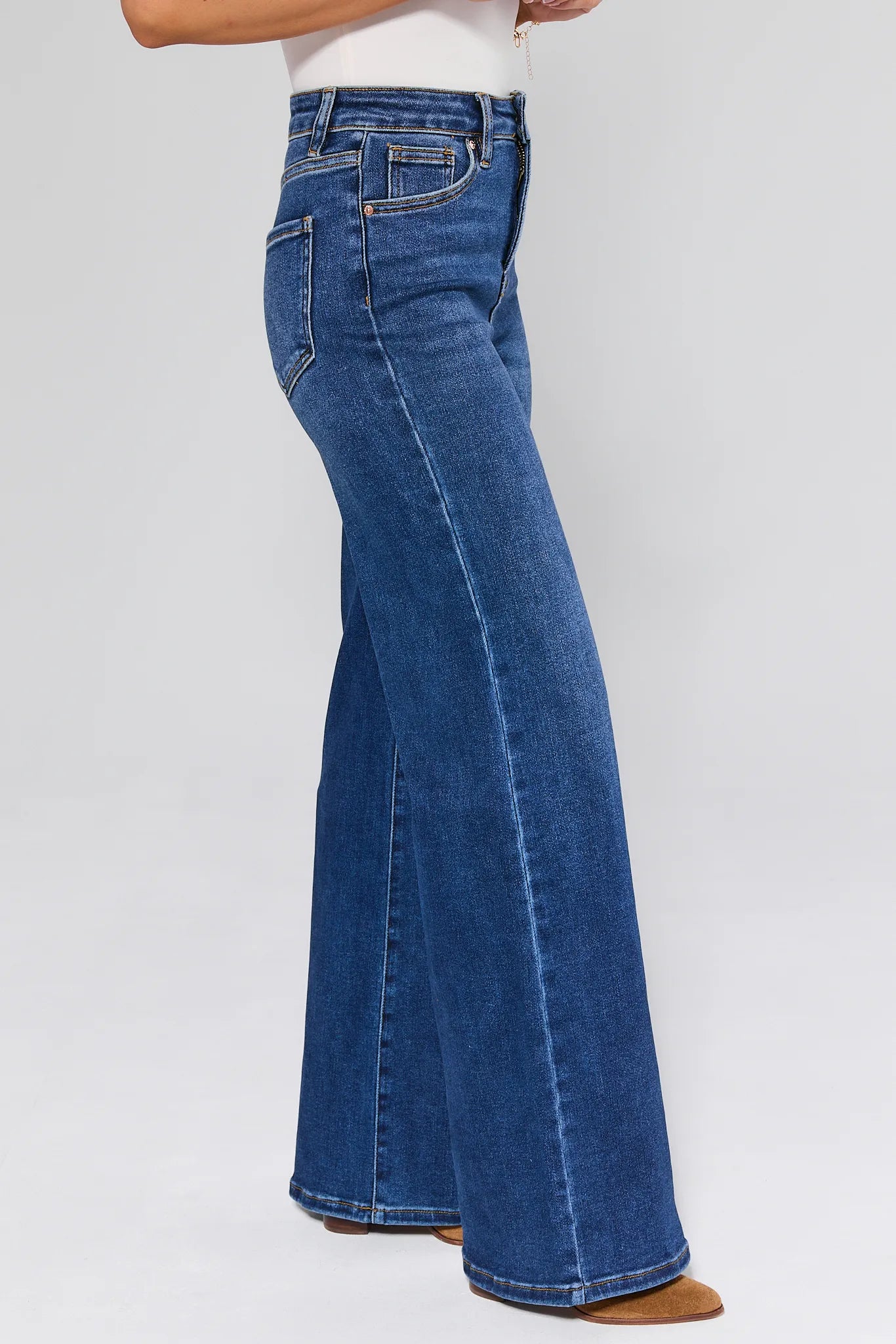 Woman wearing a light blue sweater with patterned design and Linda Dark Wash Wide Leg Jeans on a white background