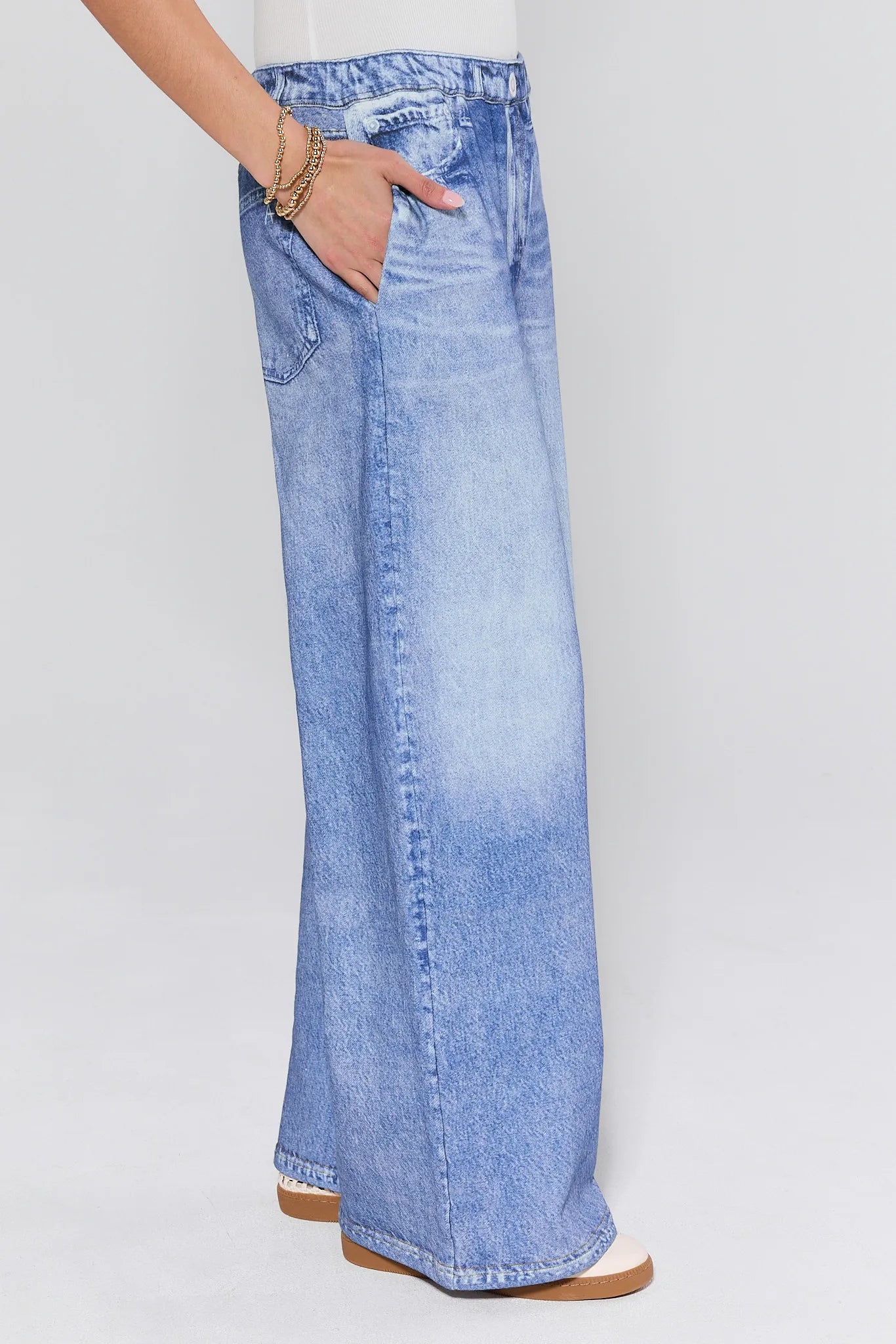 Light blue wide-leg jeans worn by a person on a white background
