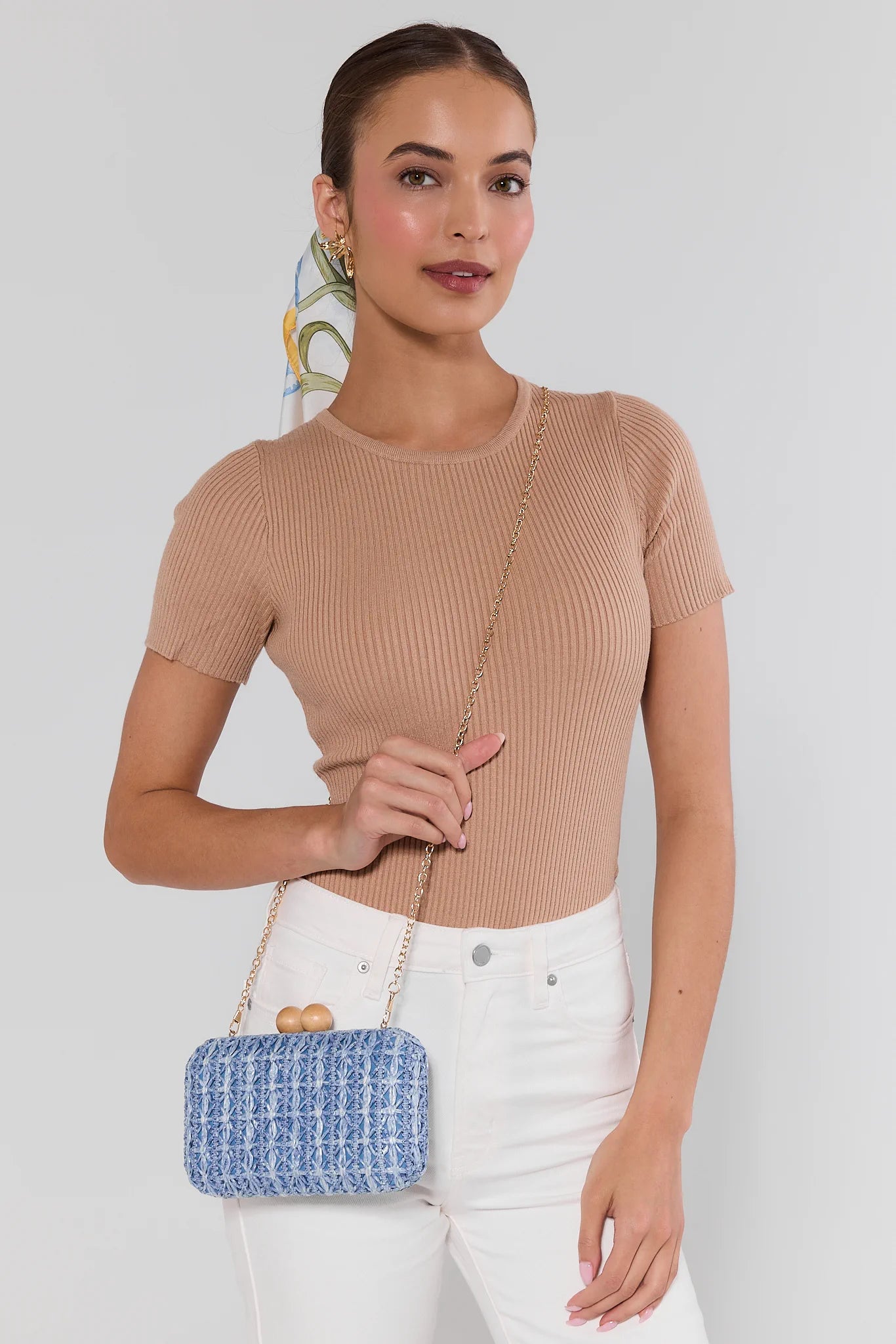 woman wearing Martha Blue Woven Clutch on white background