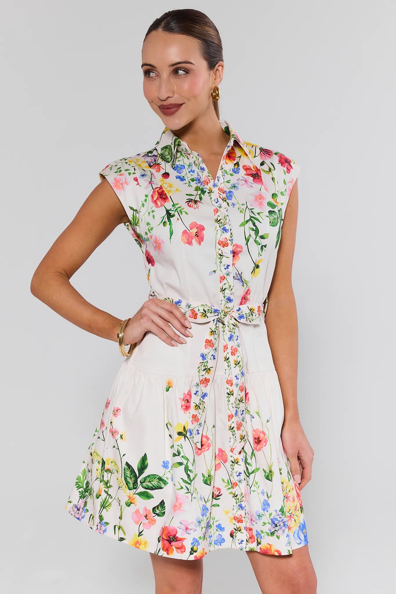 Woman wearing a floral dress against a plain background