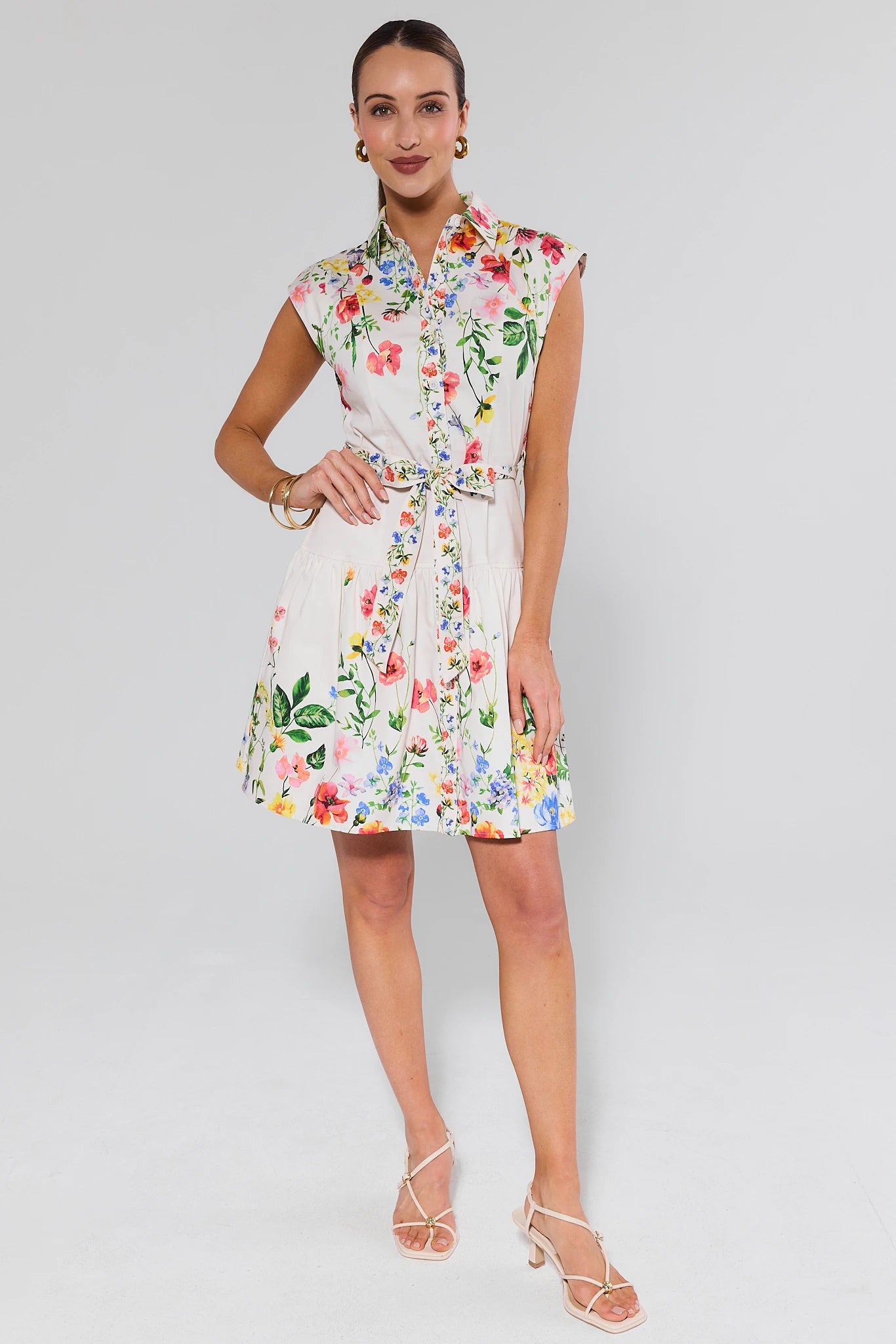 Woman wearing a floral dress on a plain background
