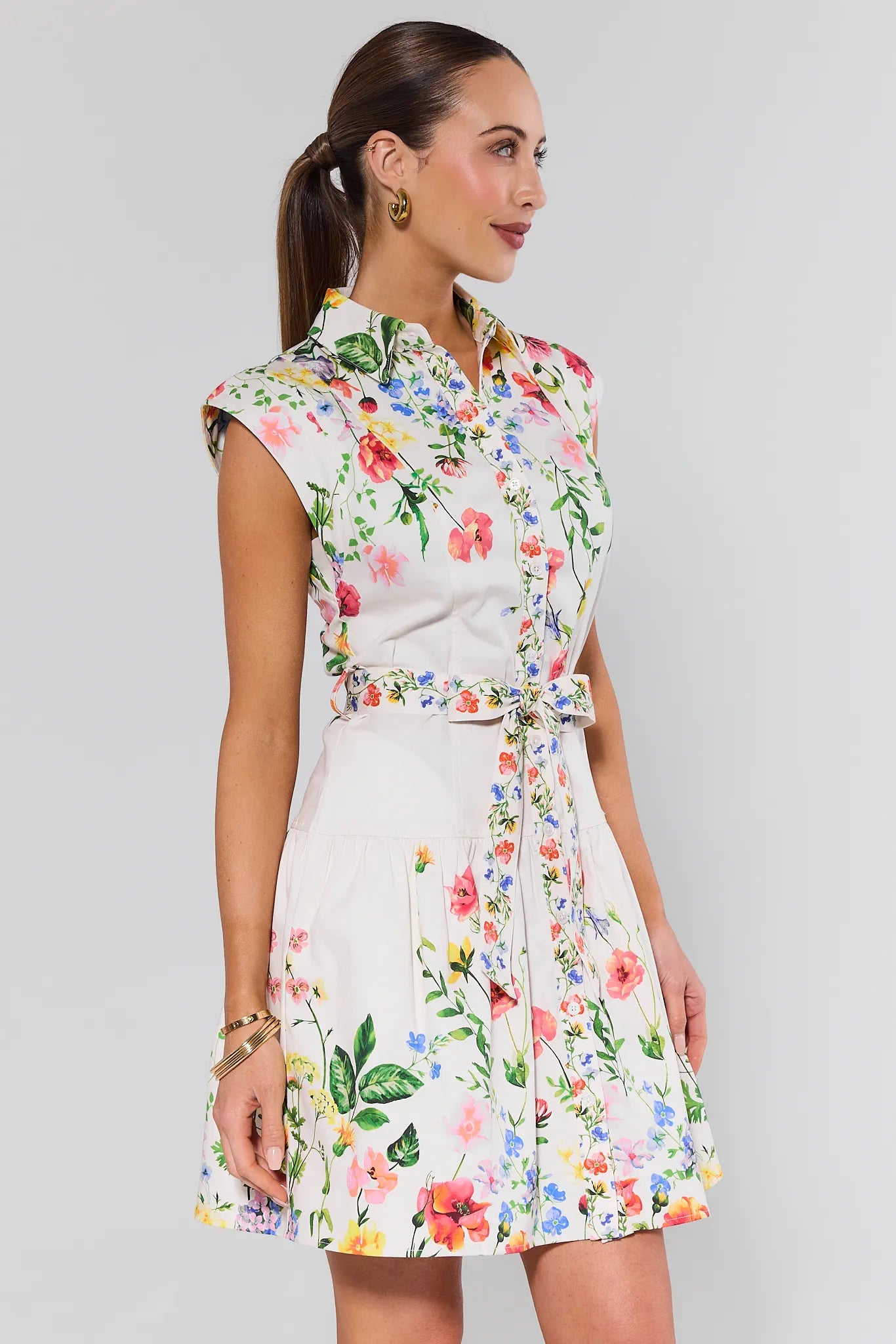 Woman wearing a floral dress against a plain background