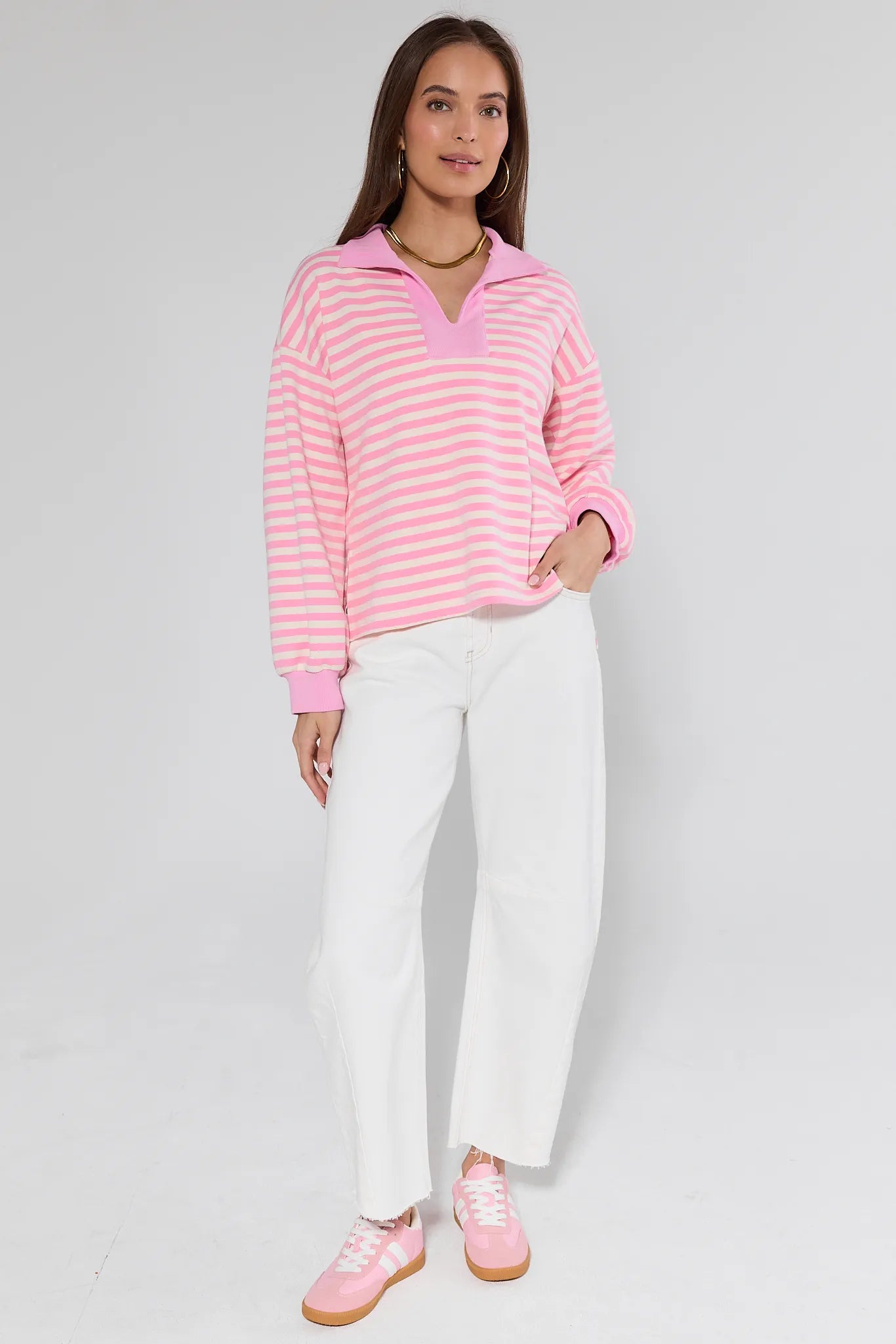 model wearing pink top with stripes on white background