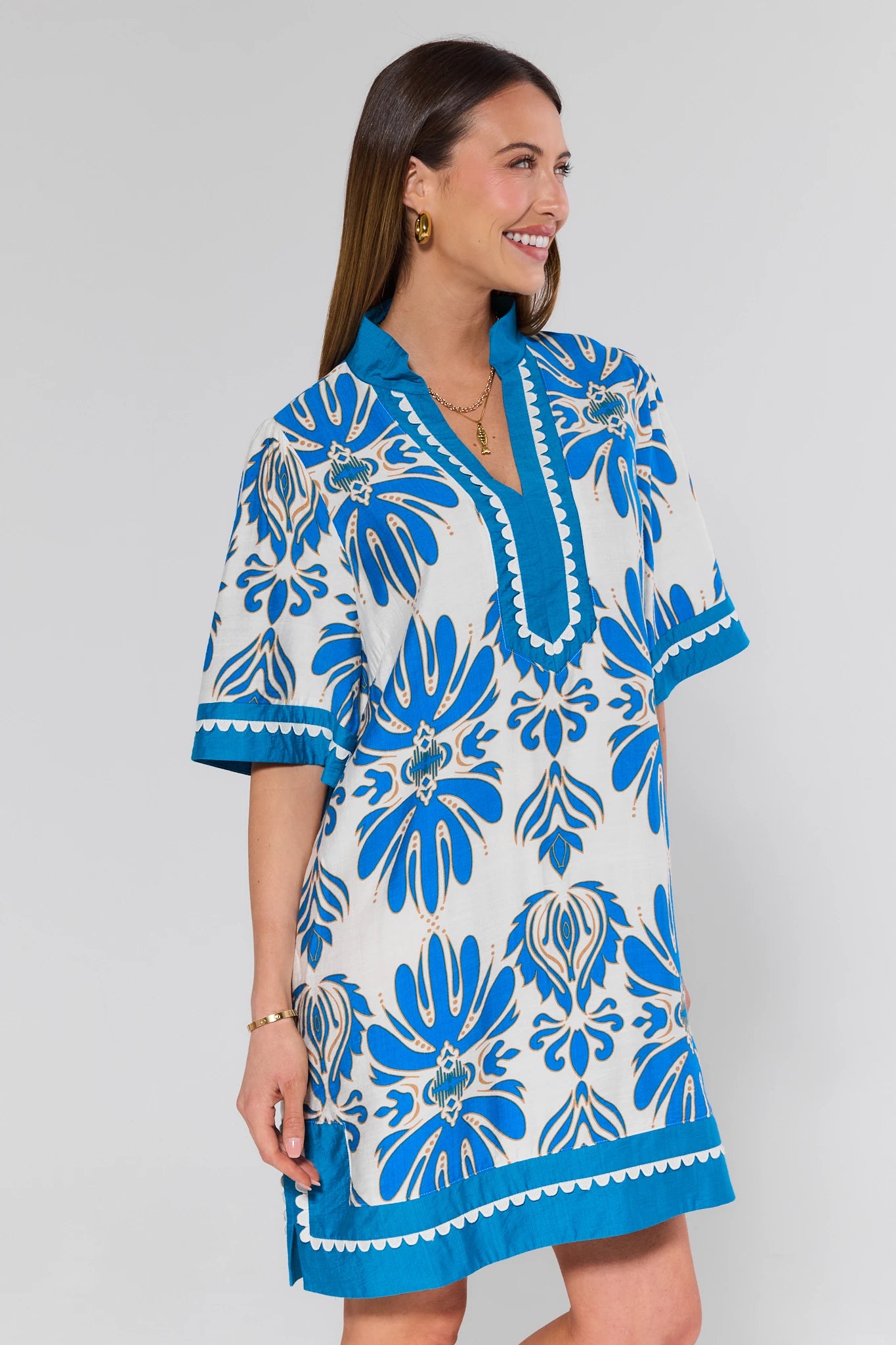 Woman wearing a blue floral dress on a white background
