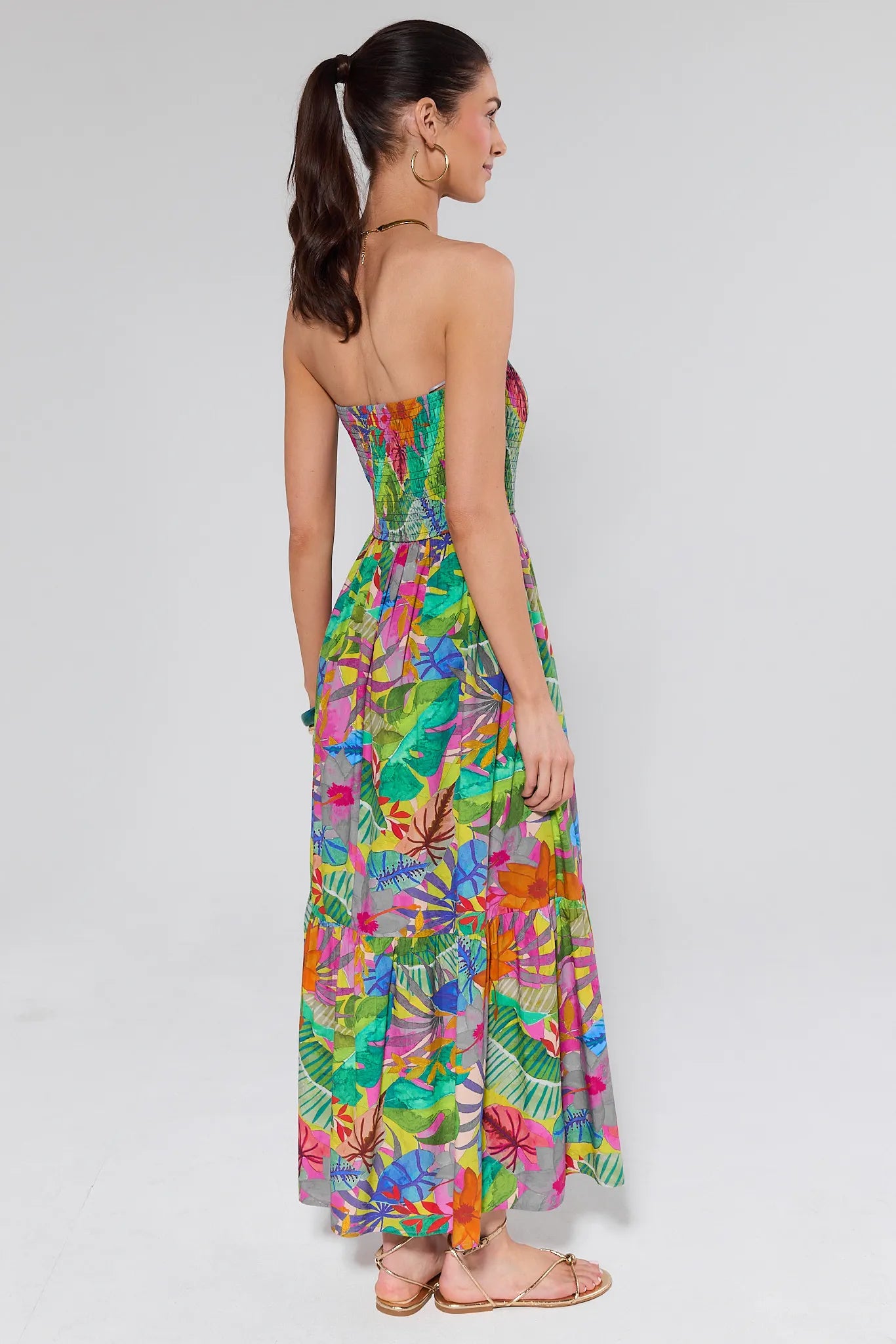 Woman wearing a colorful floral dress on a white background