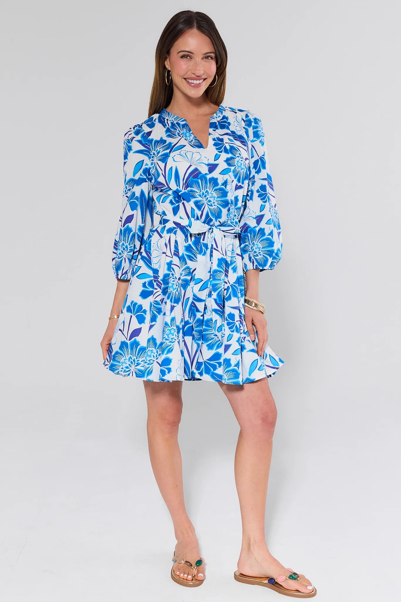 Woman wearing a blue floral dress on a white background