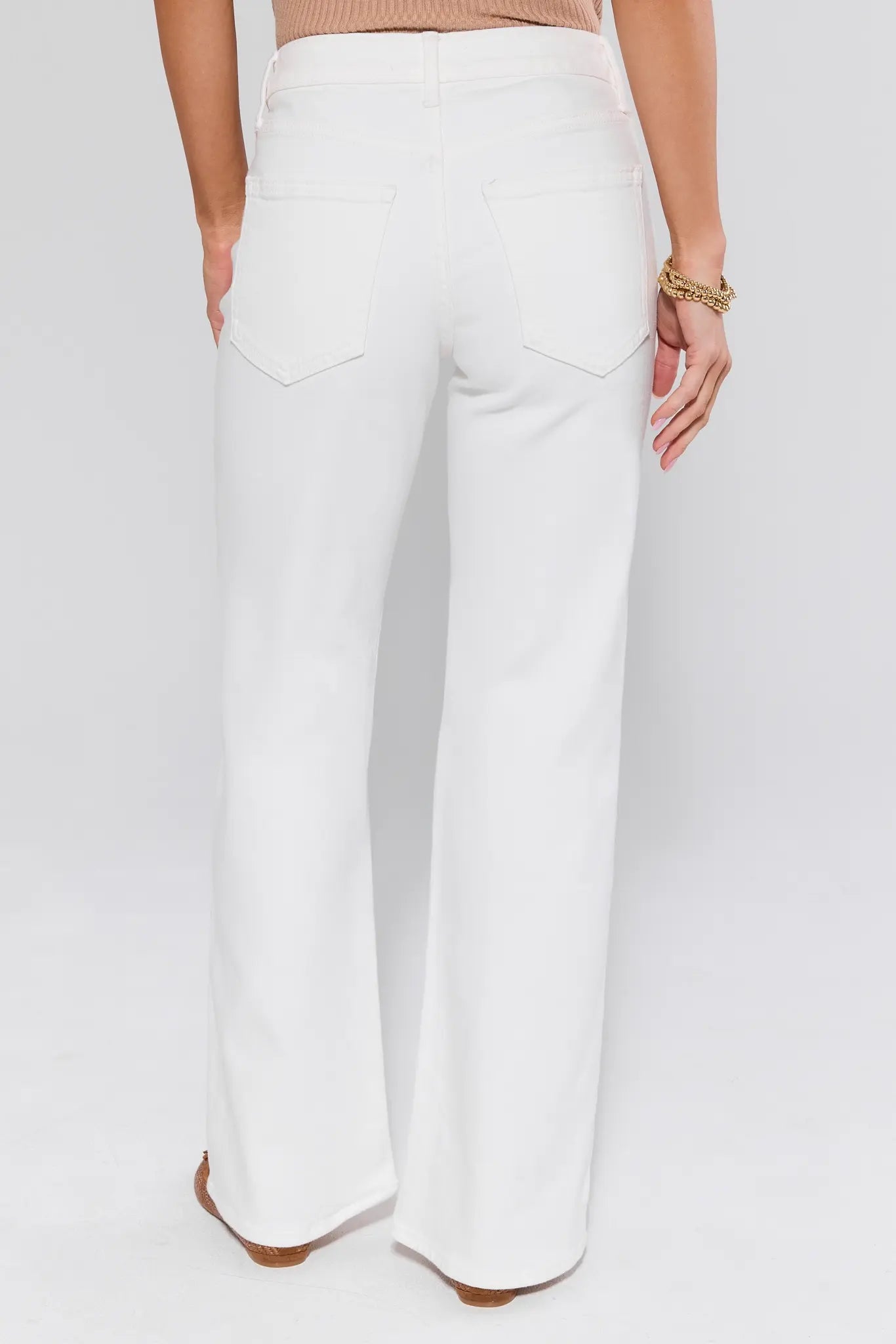 White wide-leg pants worn by a person on a white background