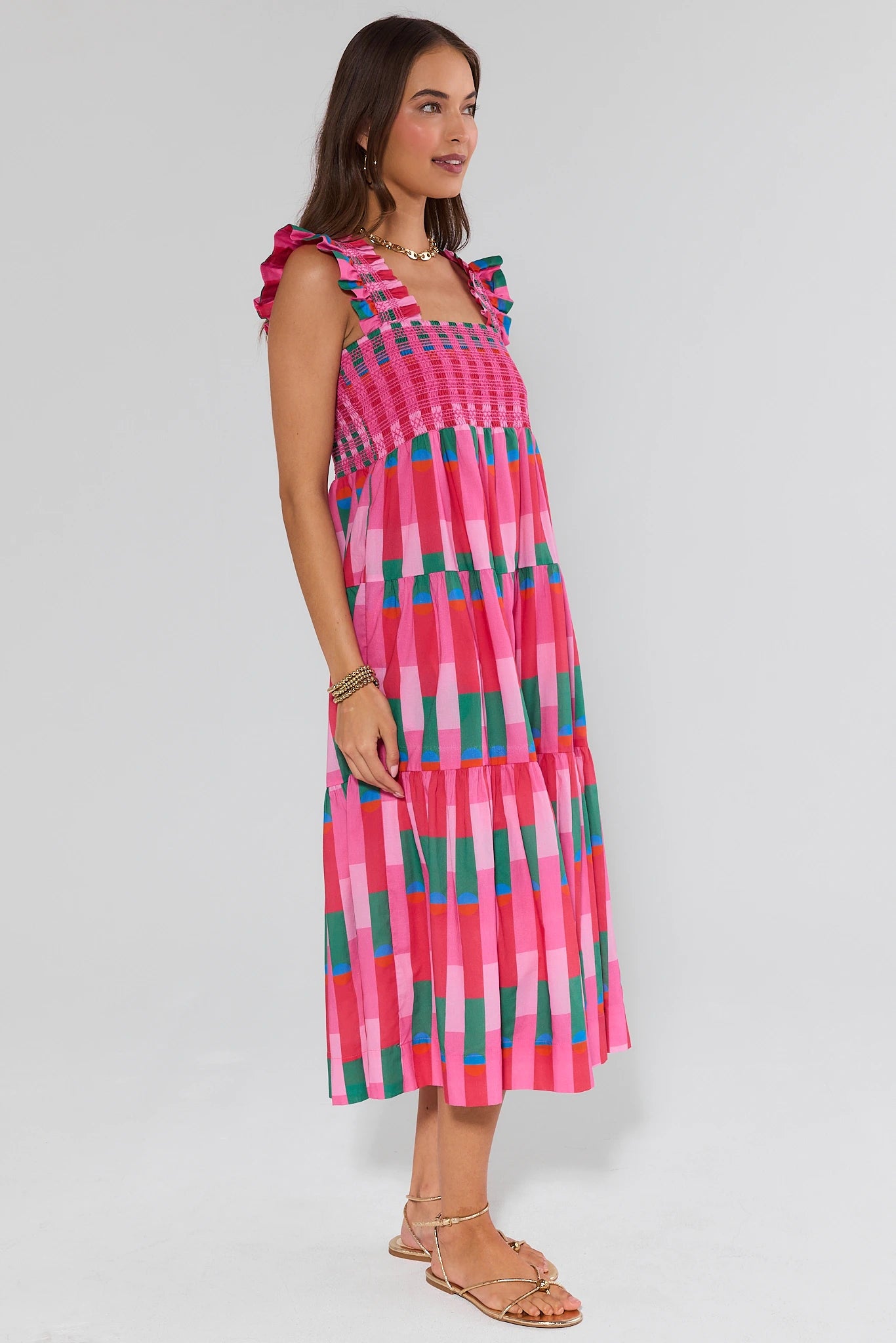 Woman wearing a colorful patterned dress on a white background