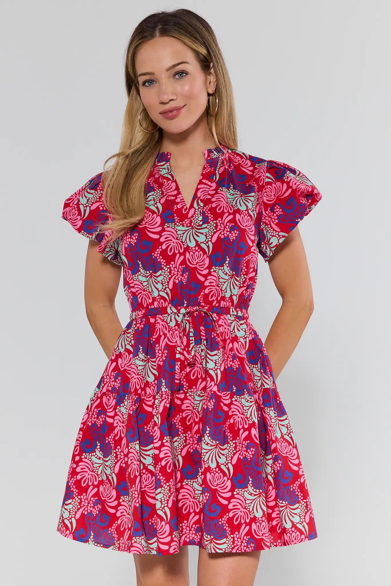 Woman wearing a colorful floral dress on a white background