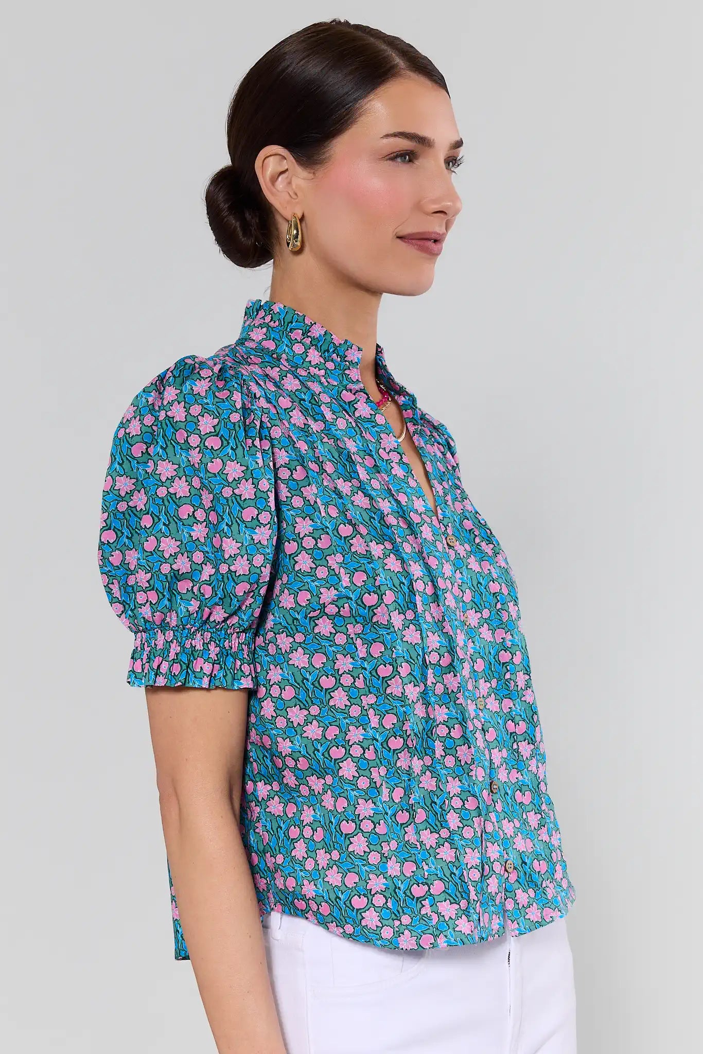 Woman wearing a floral blouse with a plain background