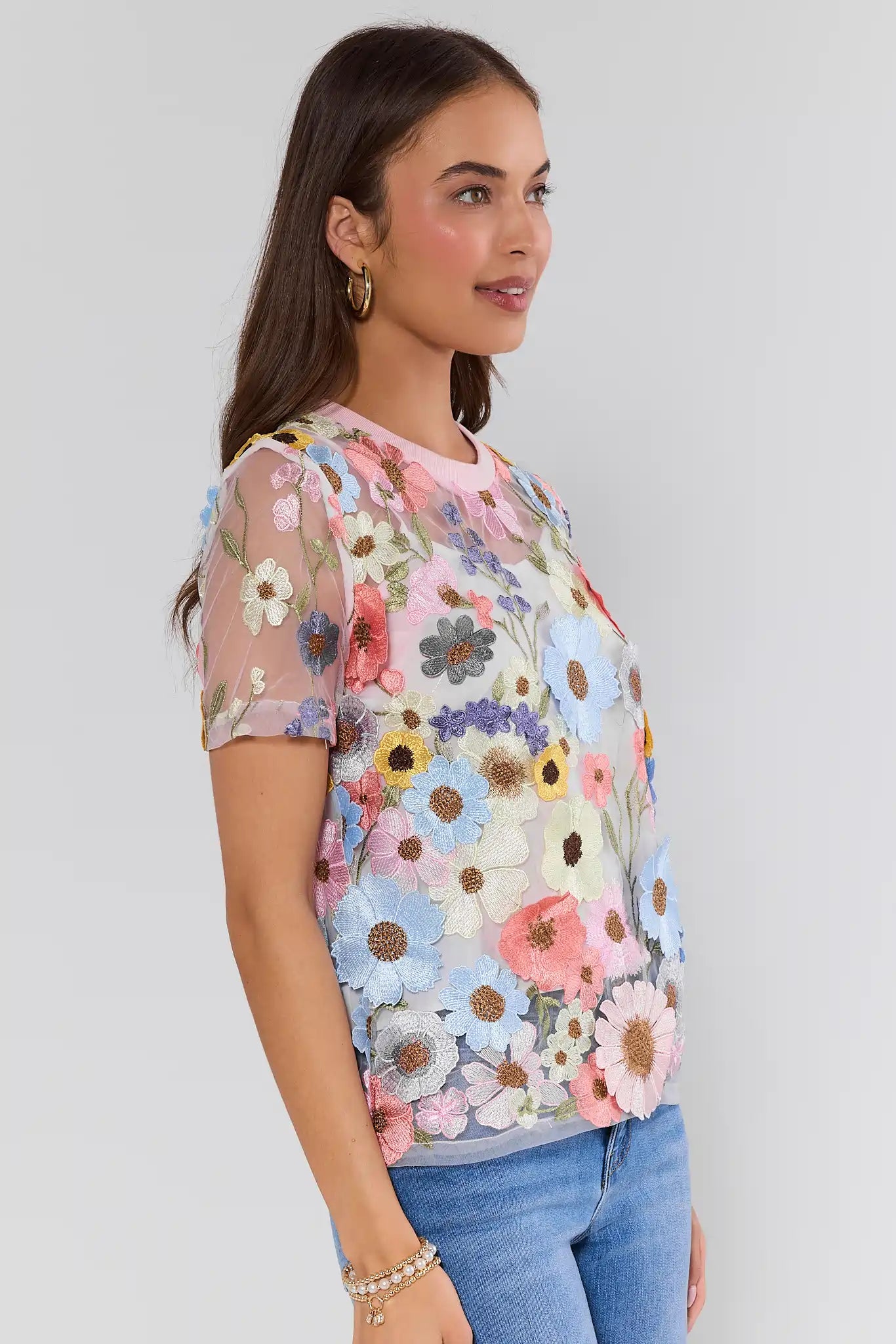 Woman wearing a floral blouse with a plain background