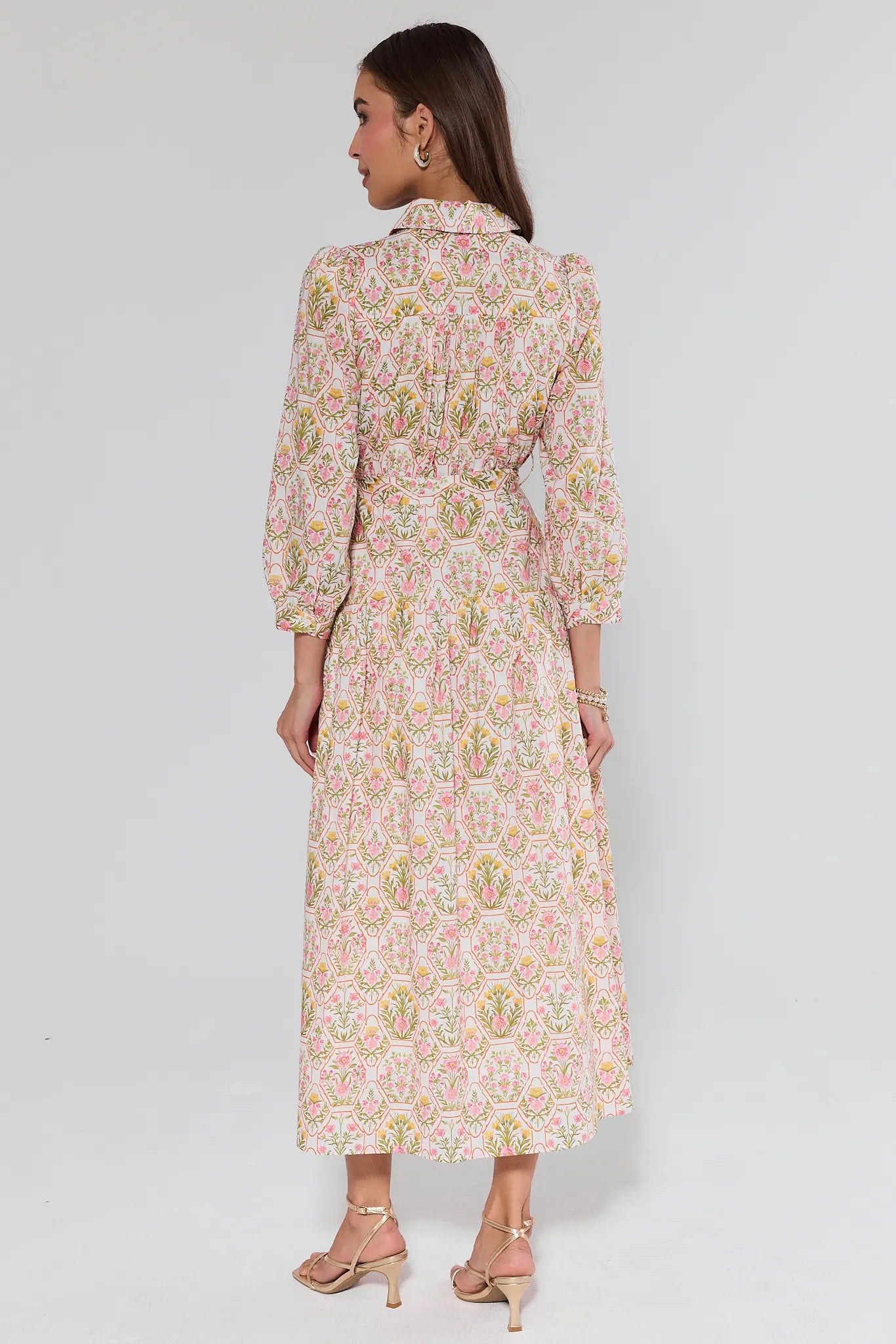 Woman wearing a floral dress on a white background