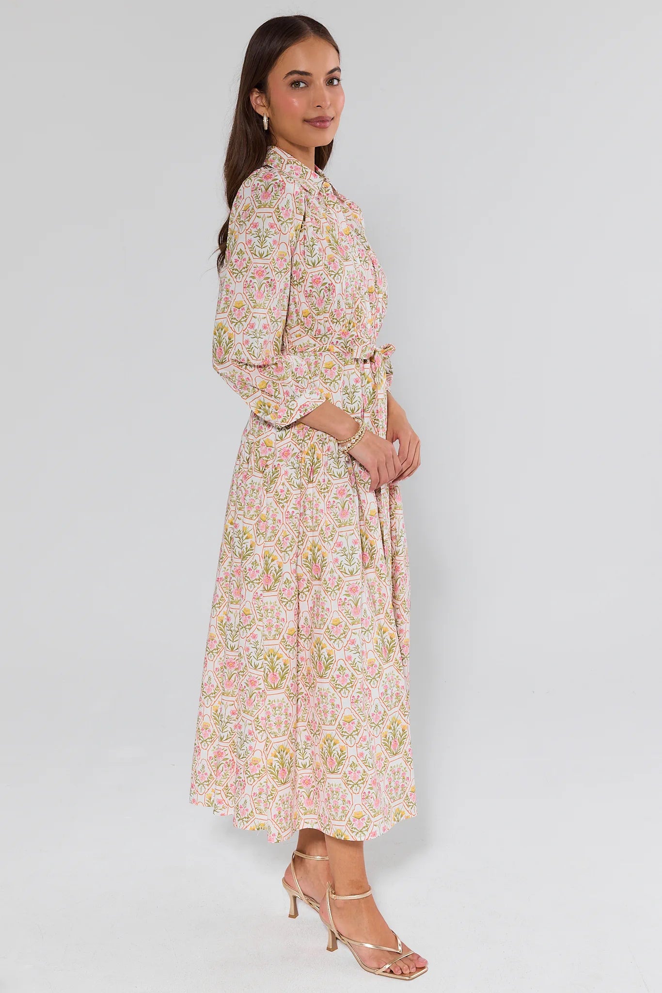 Woman wearing a floral dress against a white background