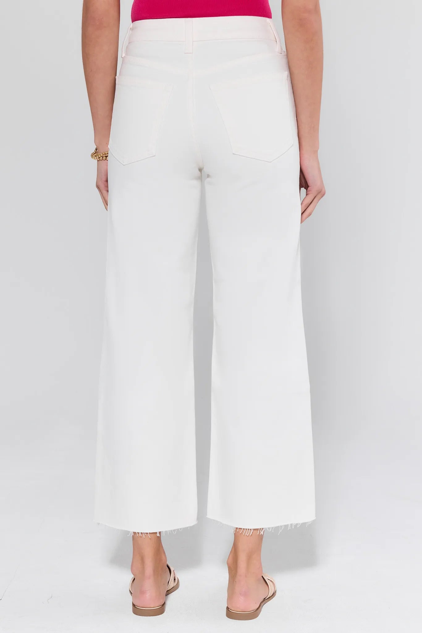 White wide-leg pants worn by a person on a white background