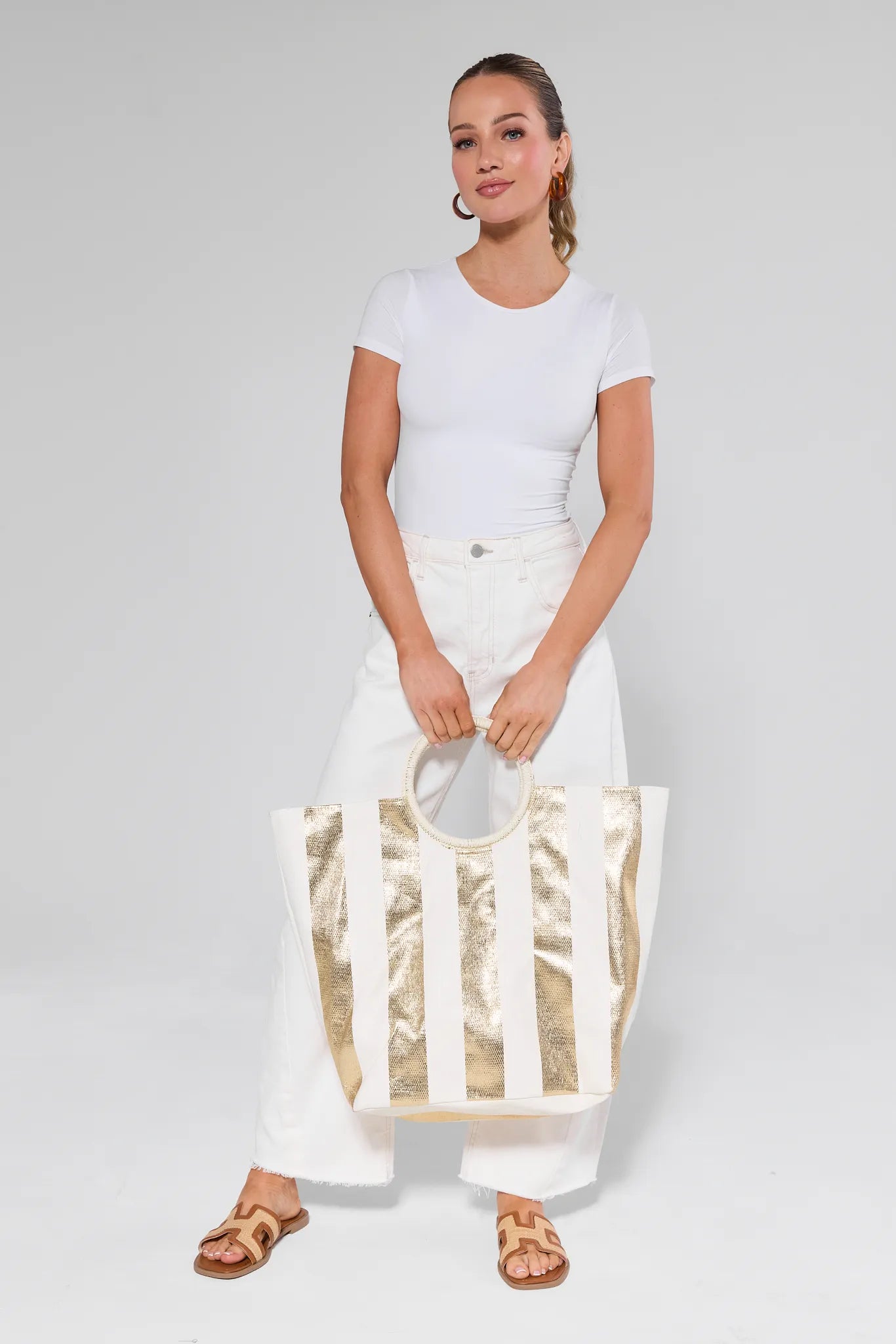 Woman holding a Maurice Tote against a plain background