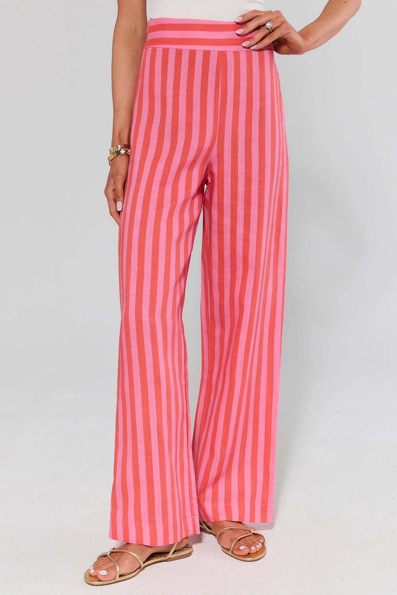 Red and white striped pants worn by a person on a plain background