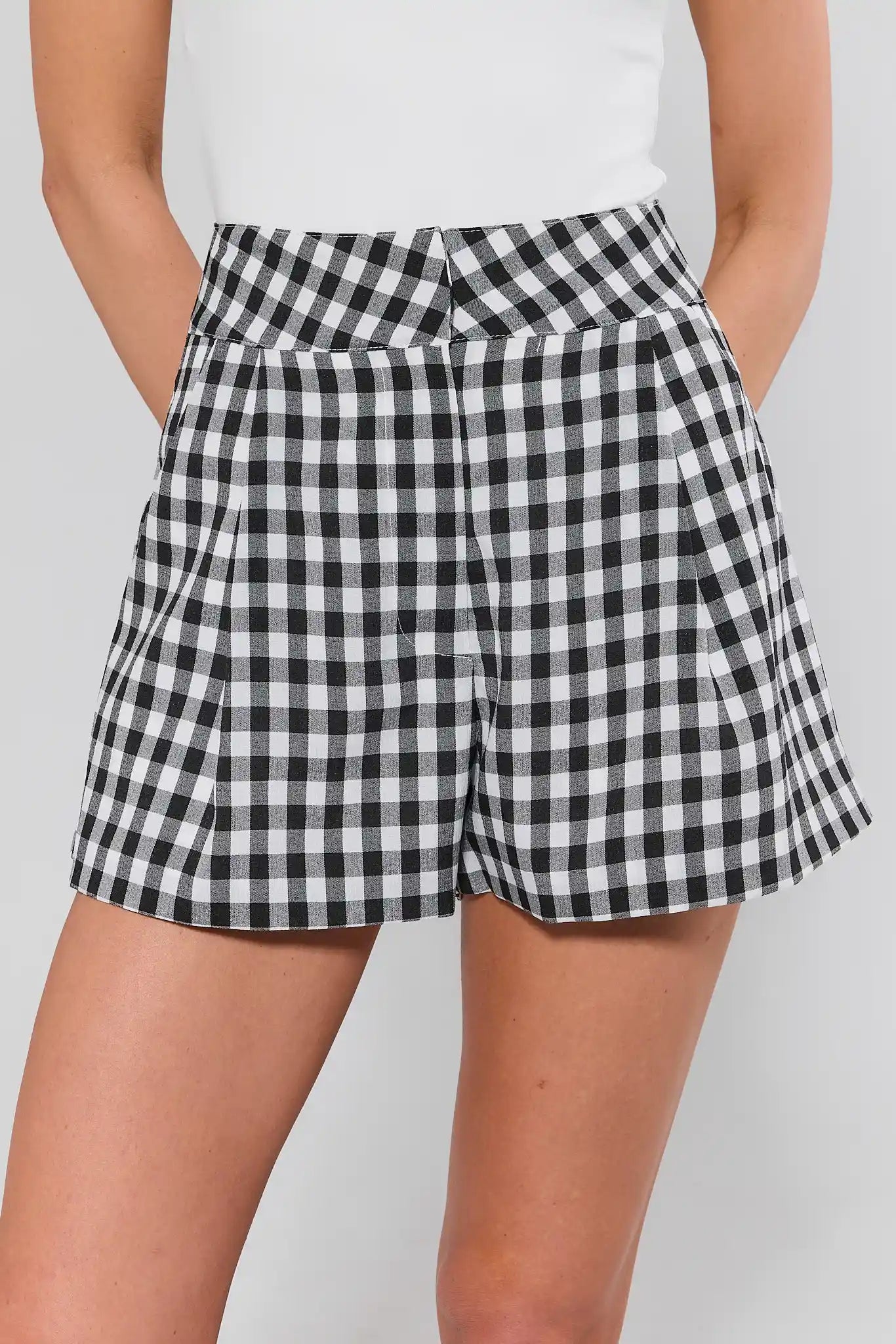 Black and white checkered shorts worn by a person on a plain background