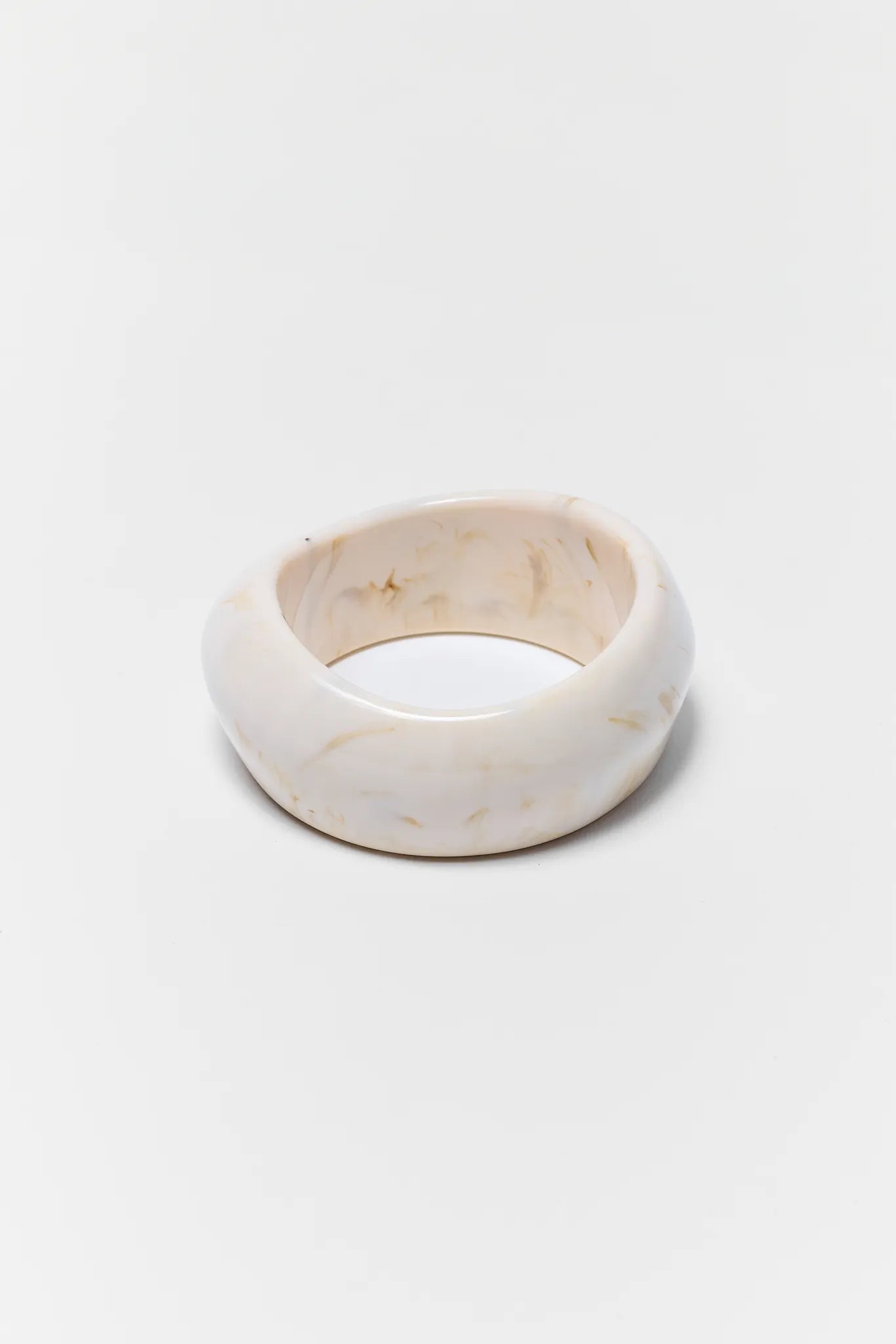 White marble ring on a light gray background