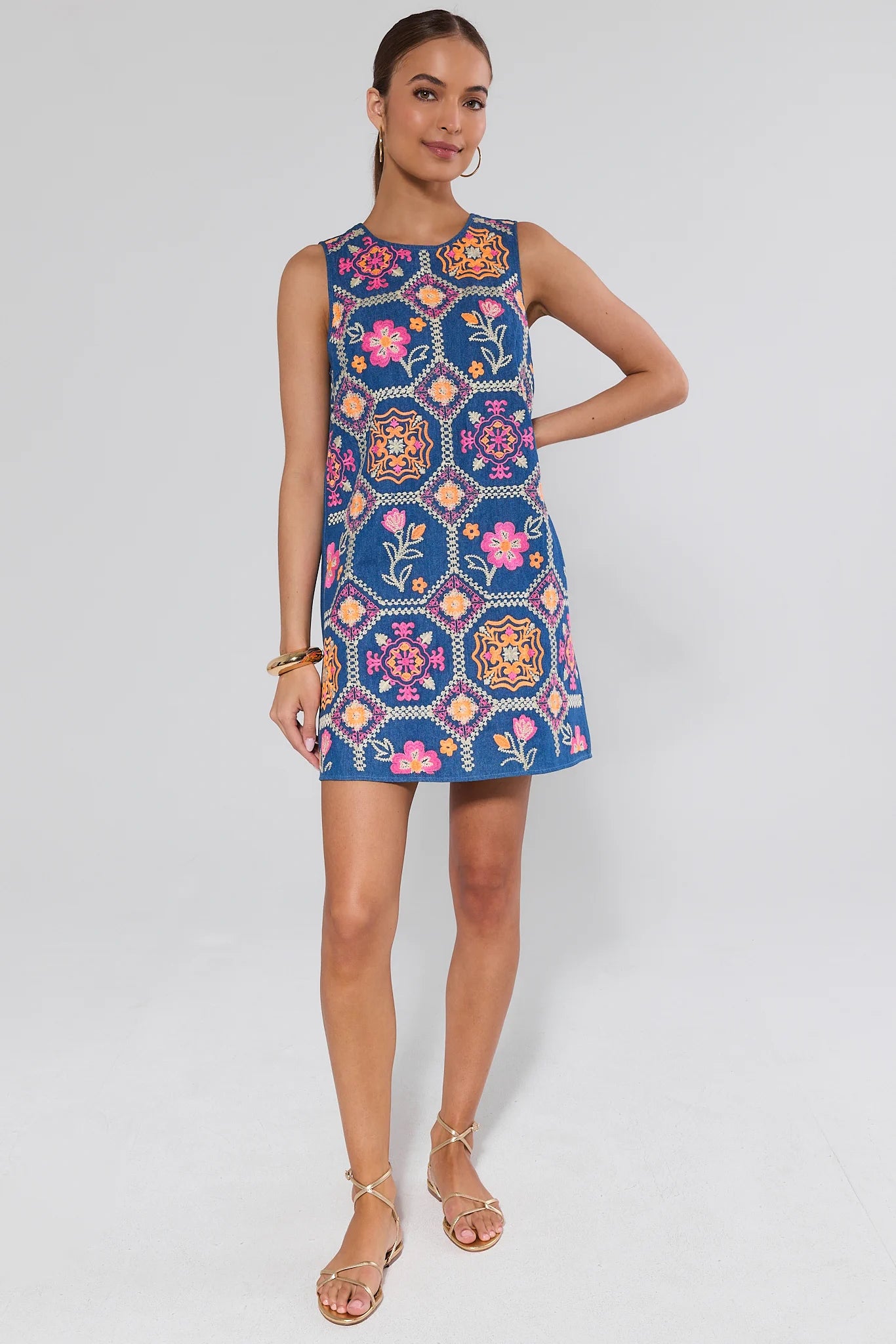 Woman wearing a colorful patterned dress on a white background