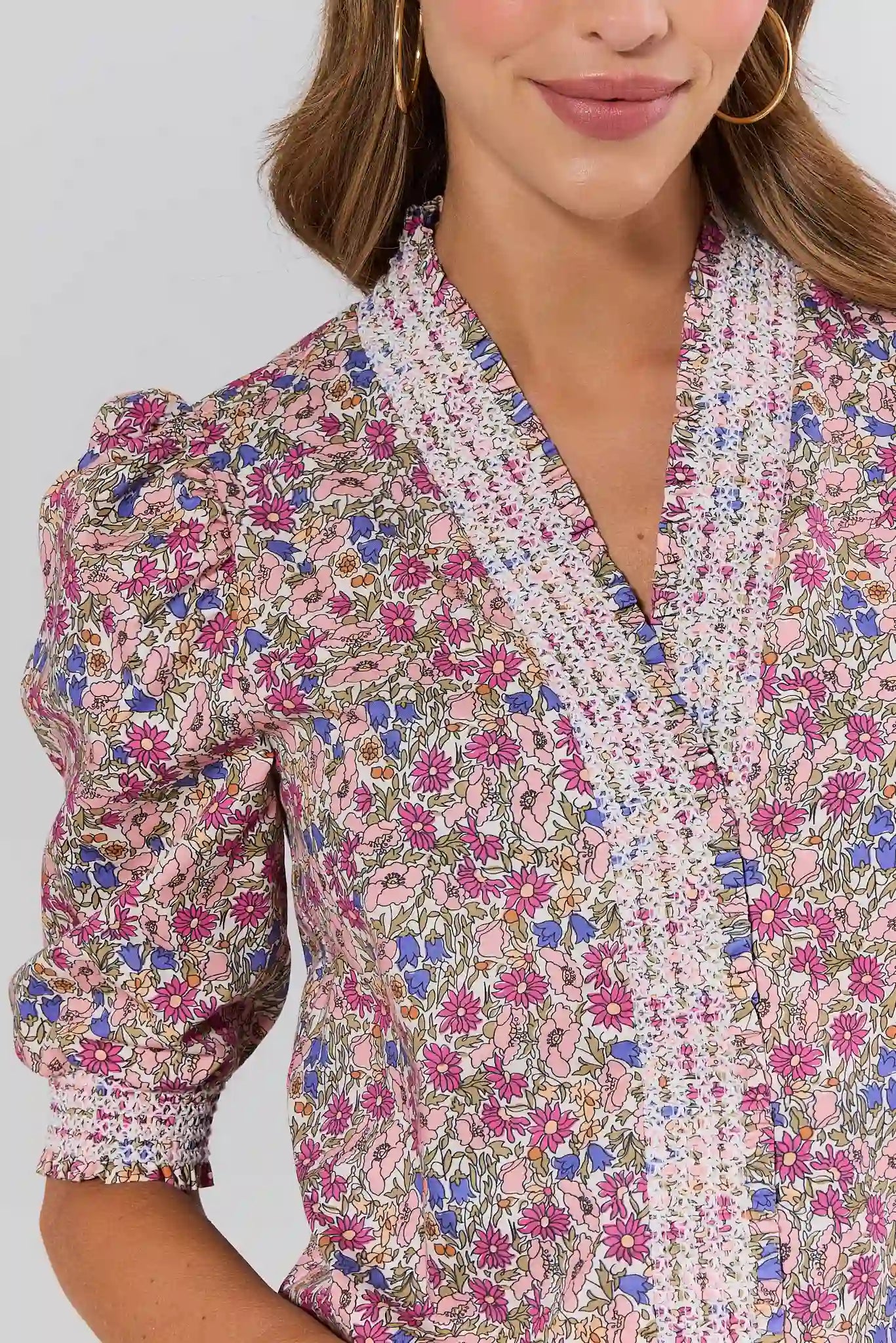 close up Woman wearing a floral blouse with a neutral background