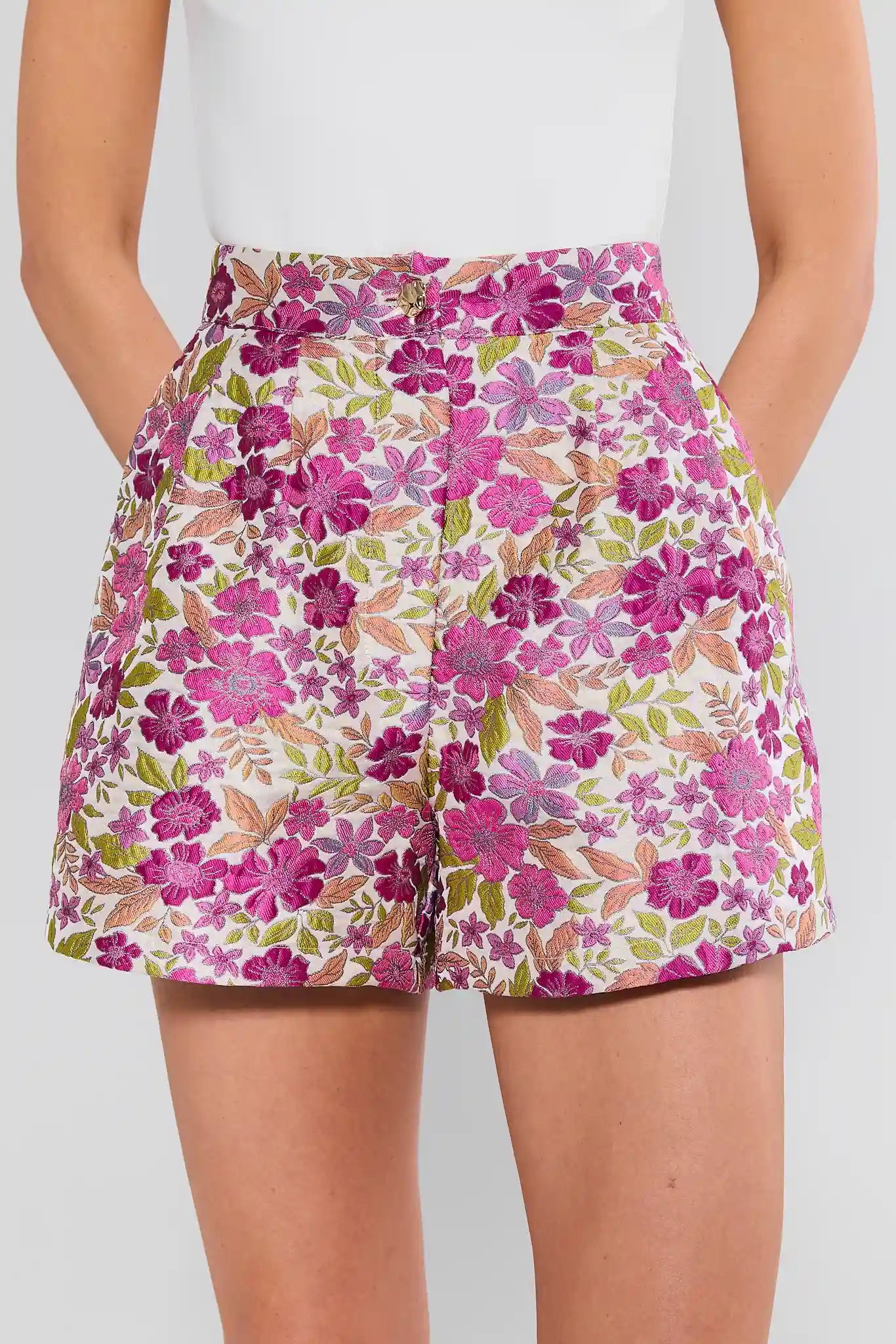 Floral shorts worn by a person on a plain background