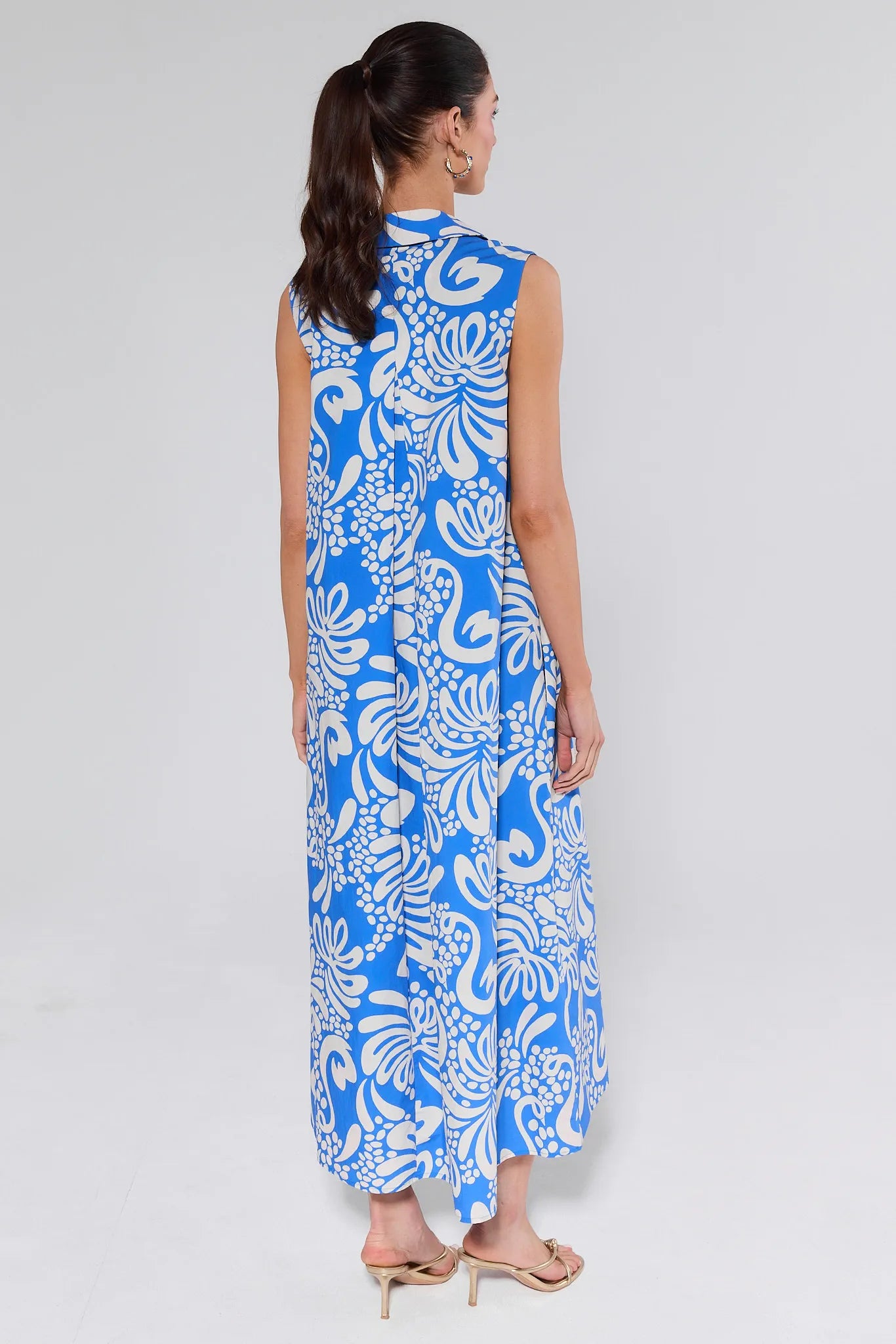 Woman wearing a blue floral dress on a white background