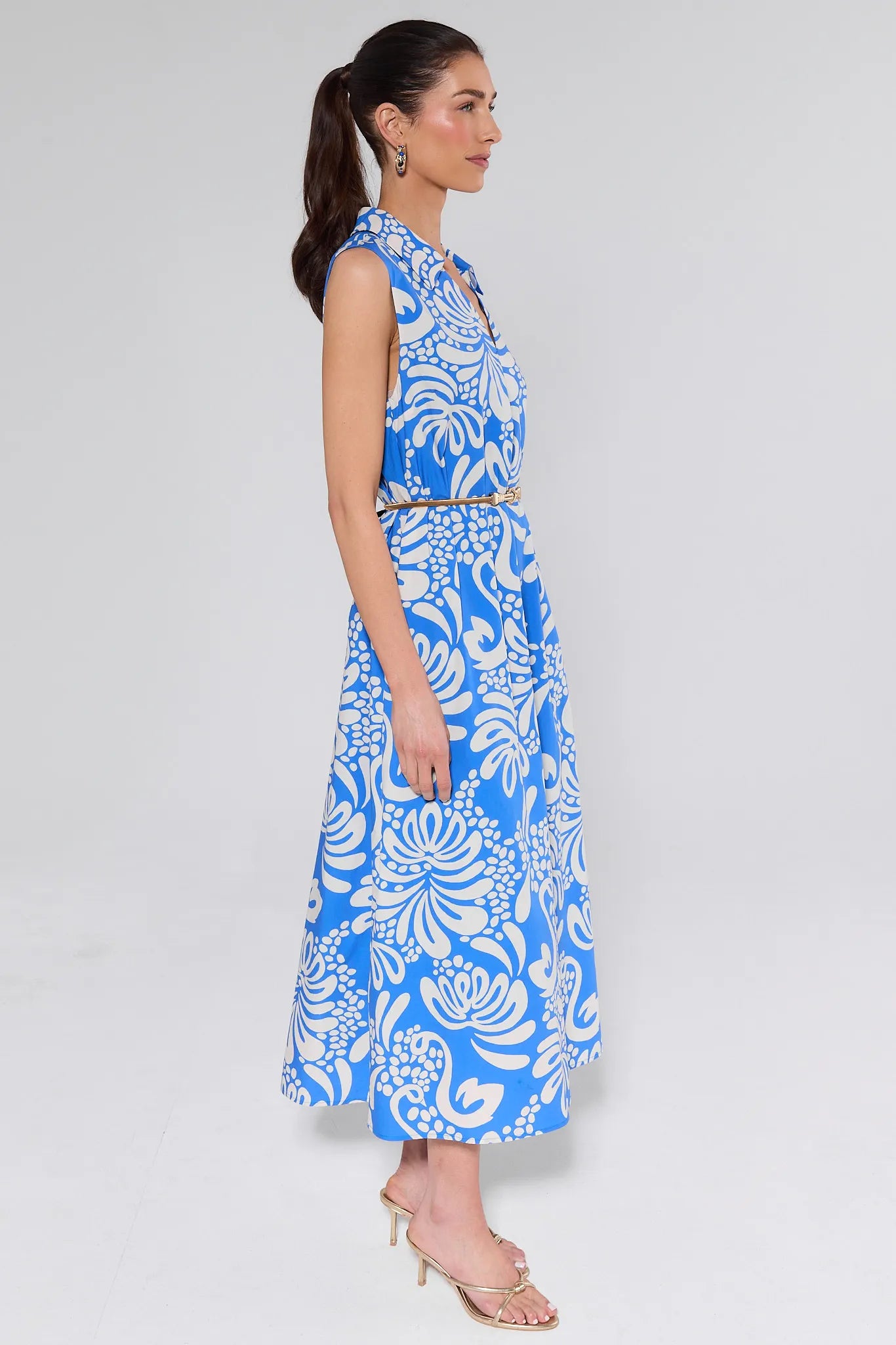 Woman wearing a blue and white floral dress on a white background