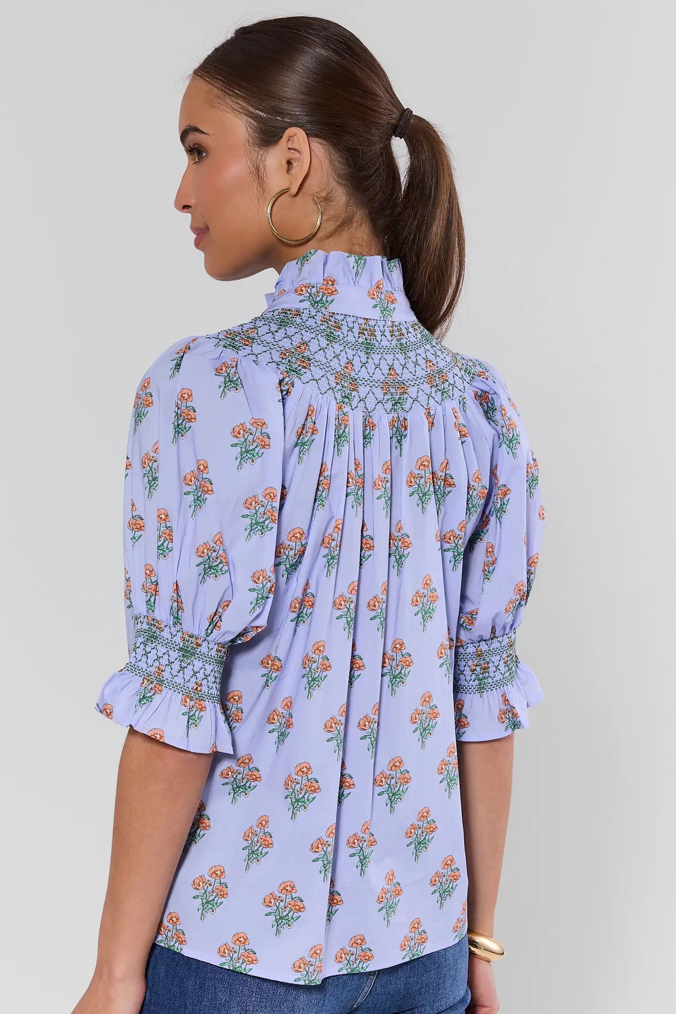 Woman wearing a floral blouse with a background