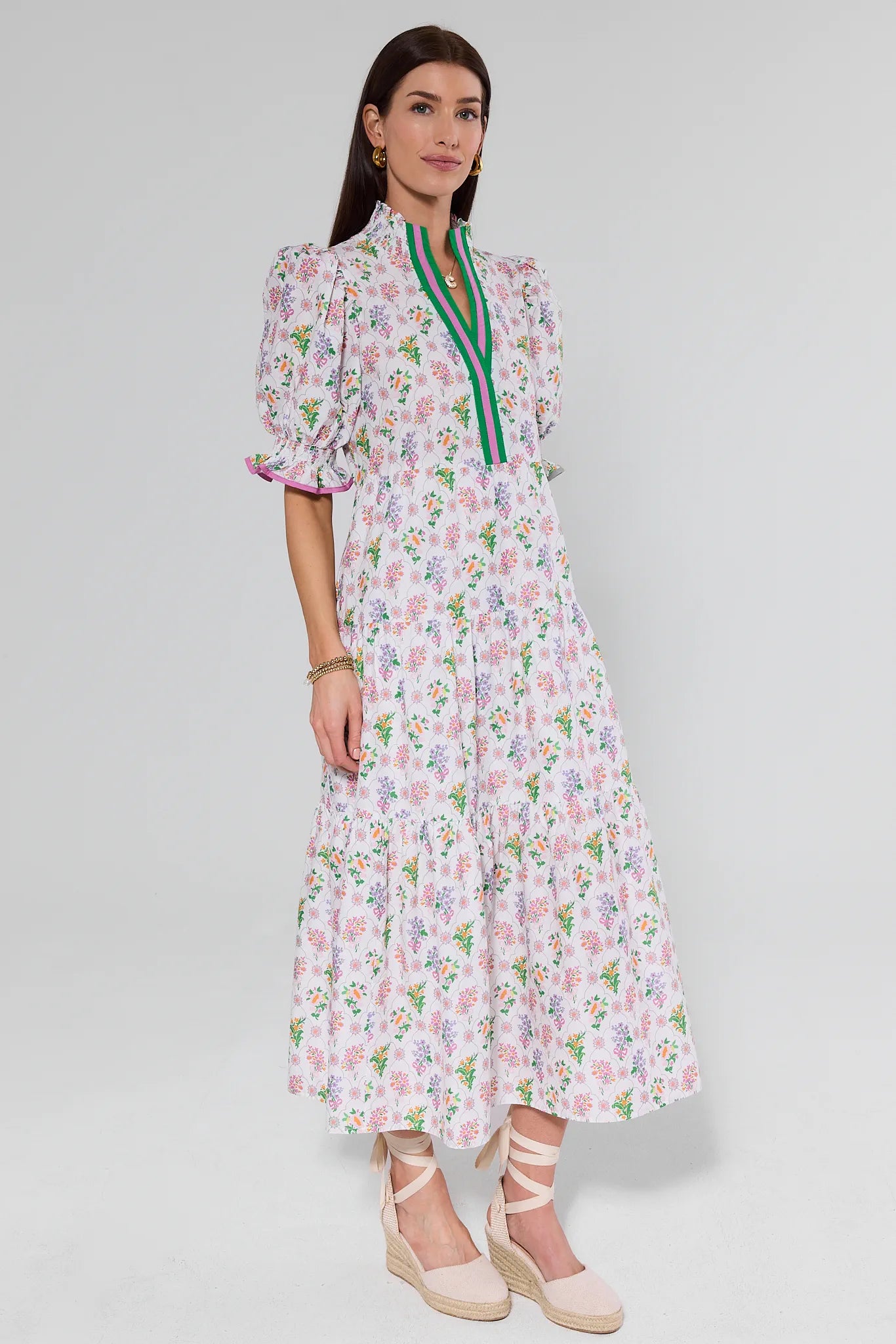 Woman wearing a floral dress with a plain background