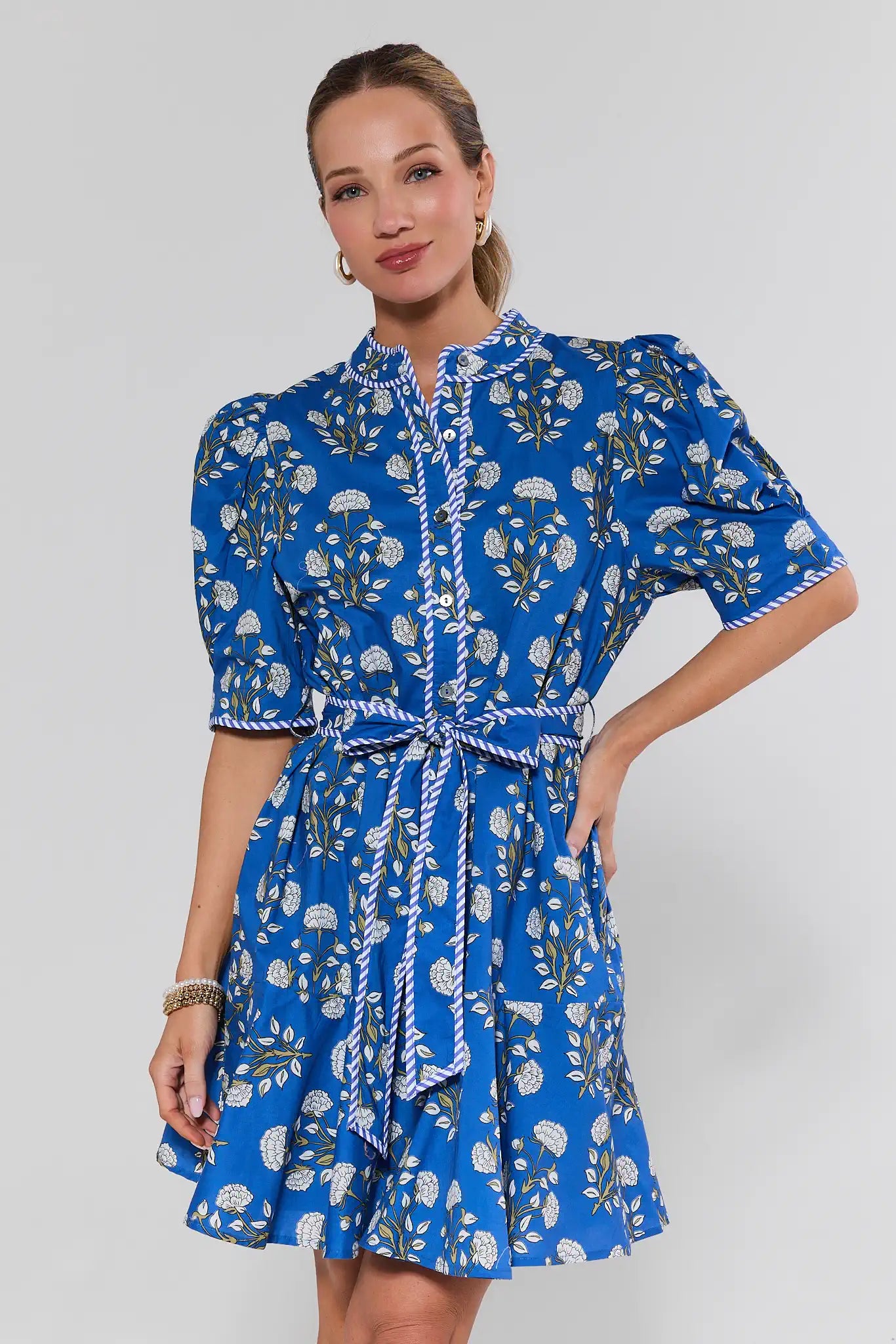 Woman wearing a blue floral dress on a white background