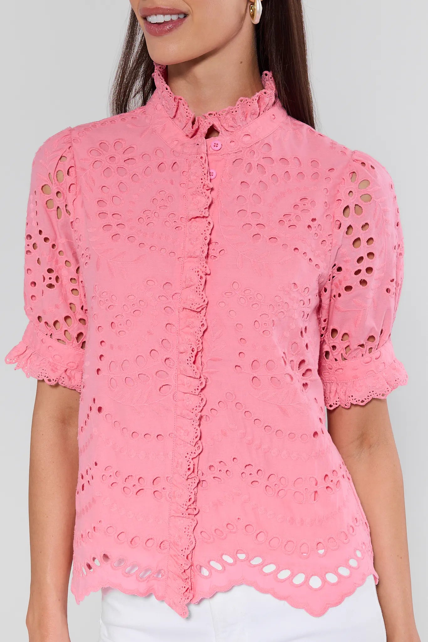 Pink lace blouse worn by a model on a plain background