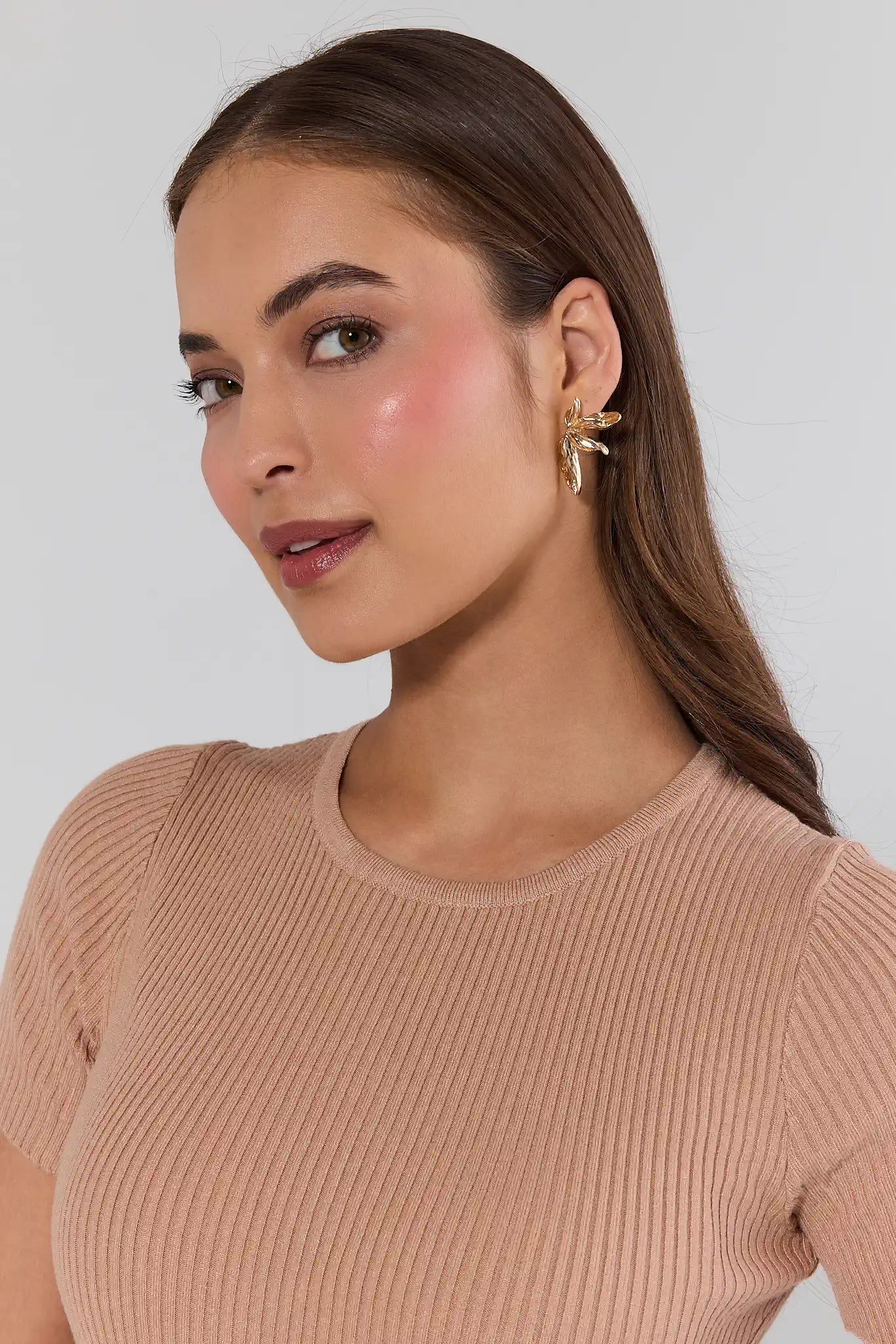 woman wearing Lillian Gold Petal Stud Earrings on white background