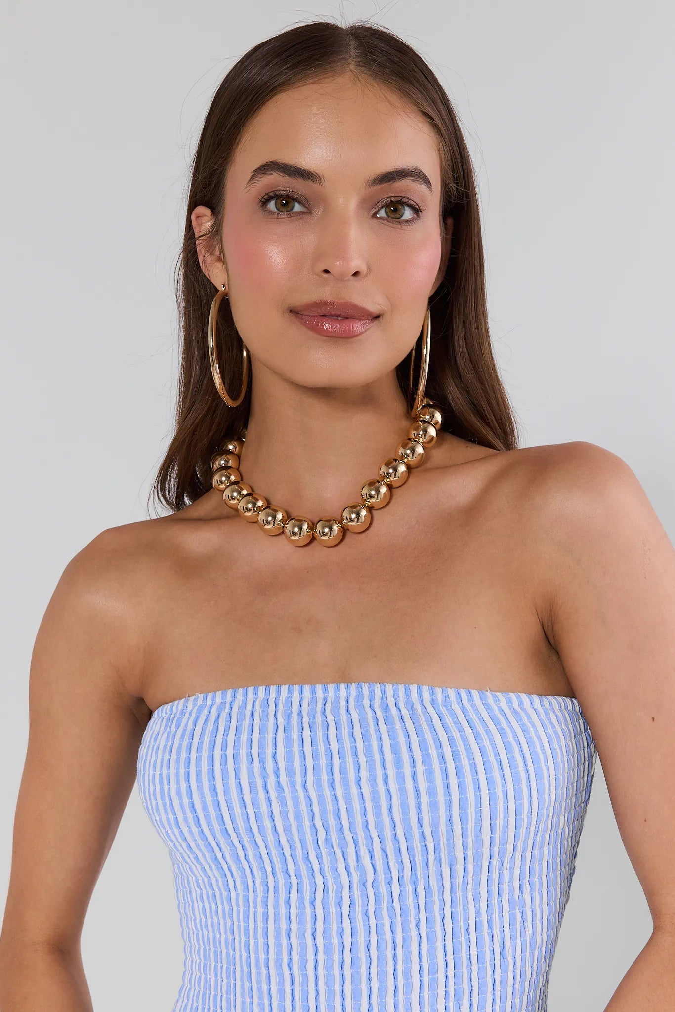 woman wearing Natasha Gold Chunky Beaded Necklace on white background