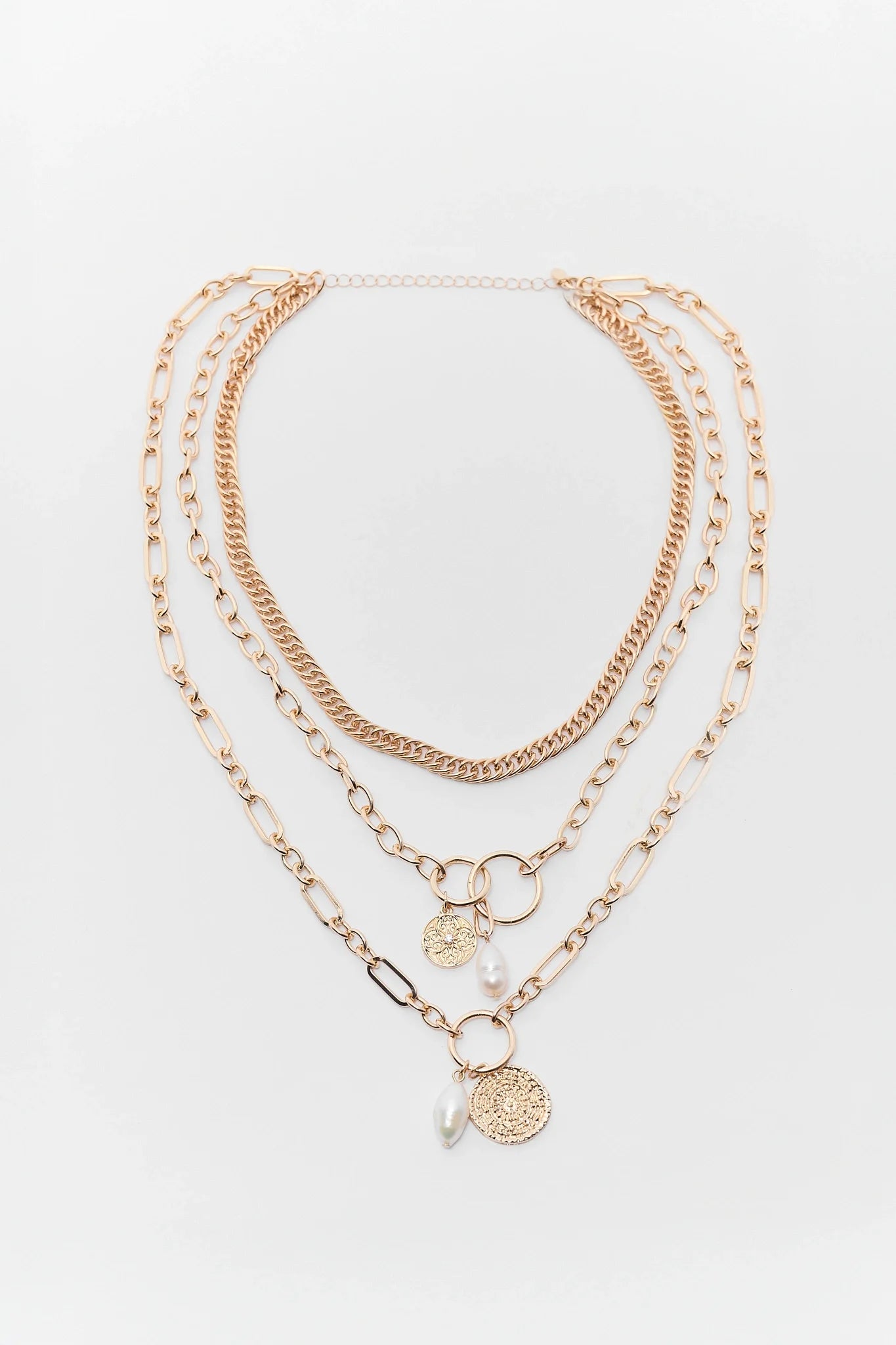 Set of gold necklaces with various pendants on a white background