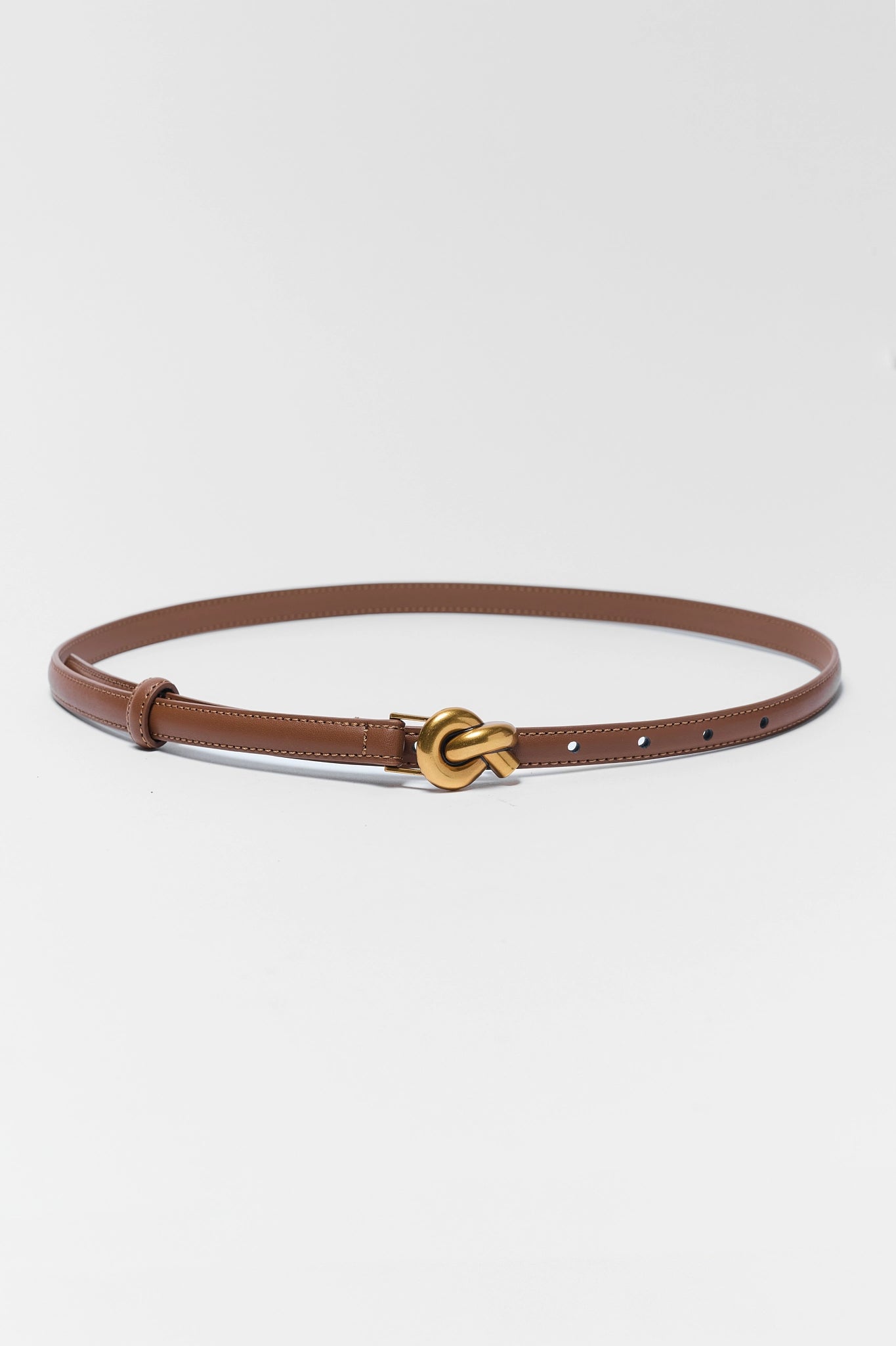Brown belt with a gold buckle on a white background