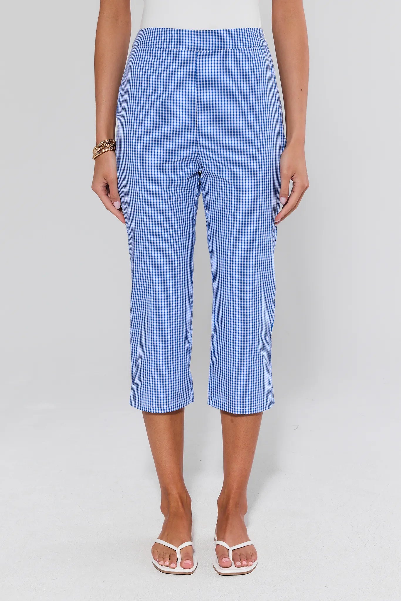 Blue checkered pants worn by a person on a white background