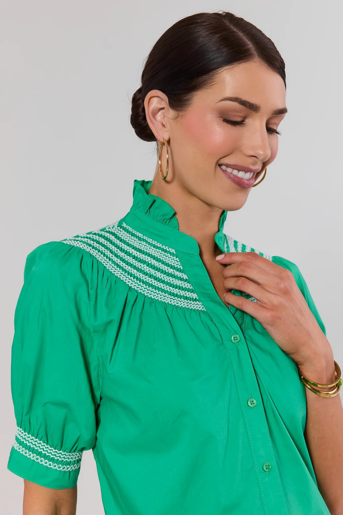 close up green yvonne top on woman on white background
