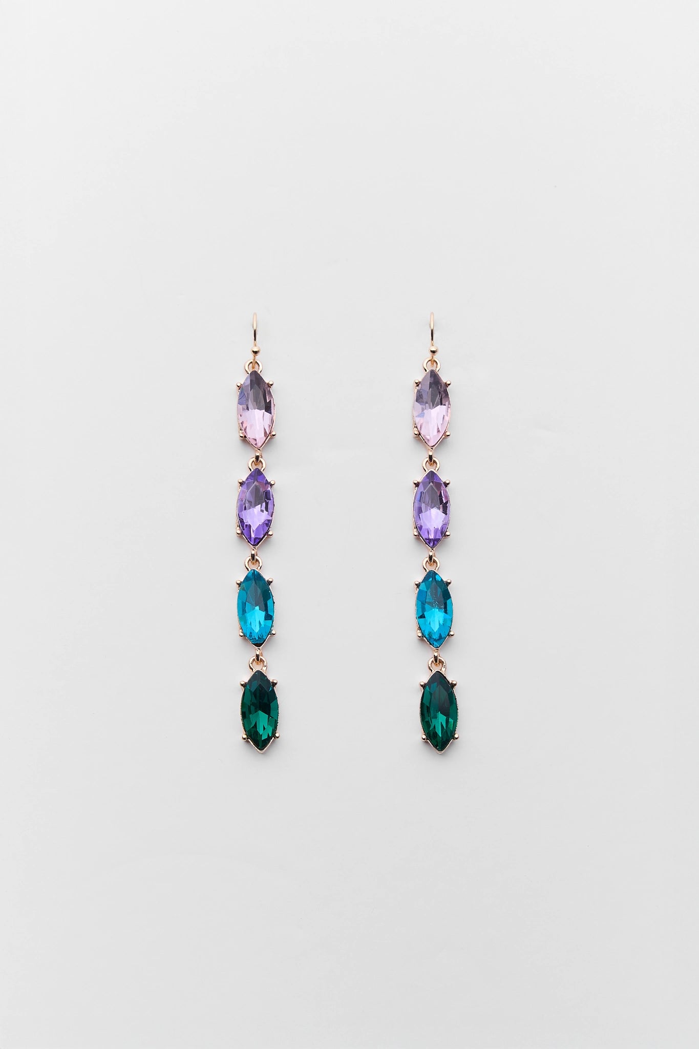 Pair of drop earrings with multicolored gemstones on a light gray background
