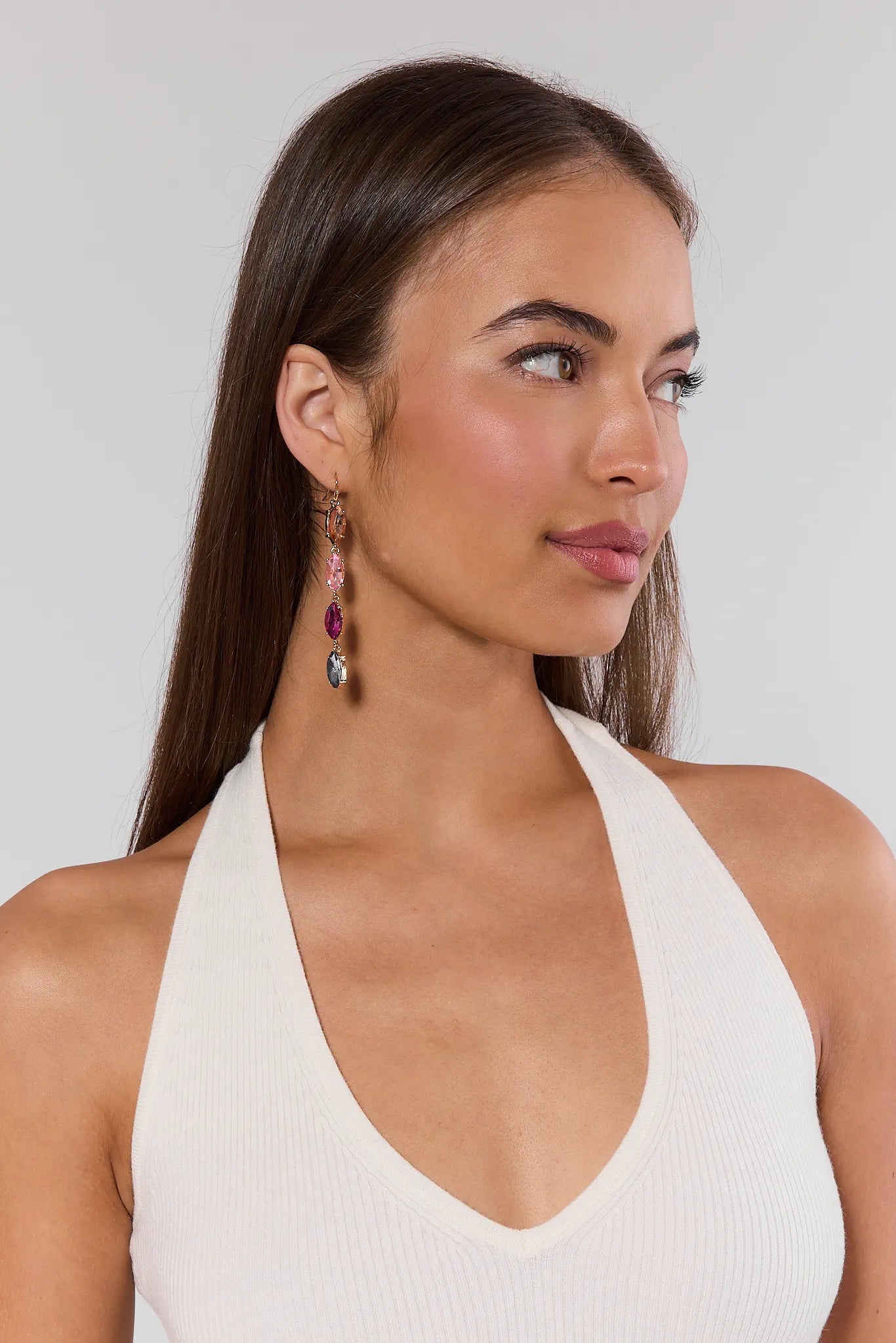 Woman wearing a white halter top against a plain background