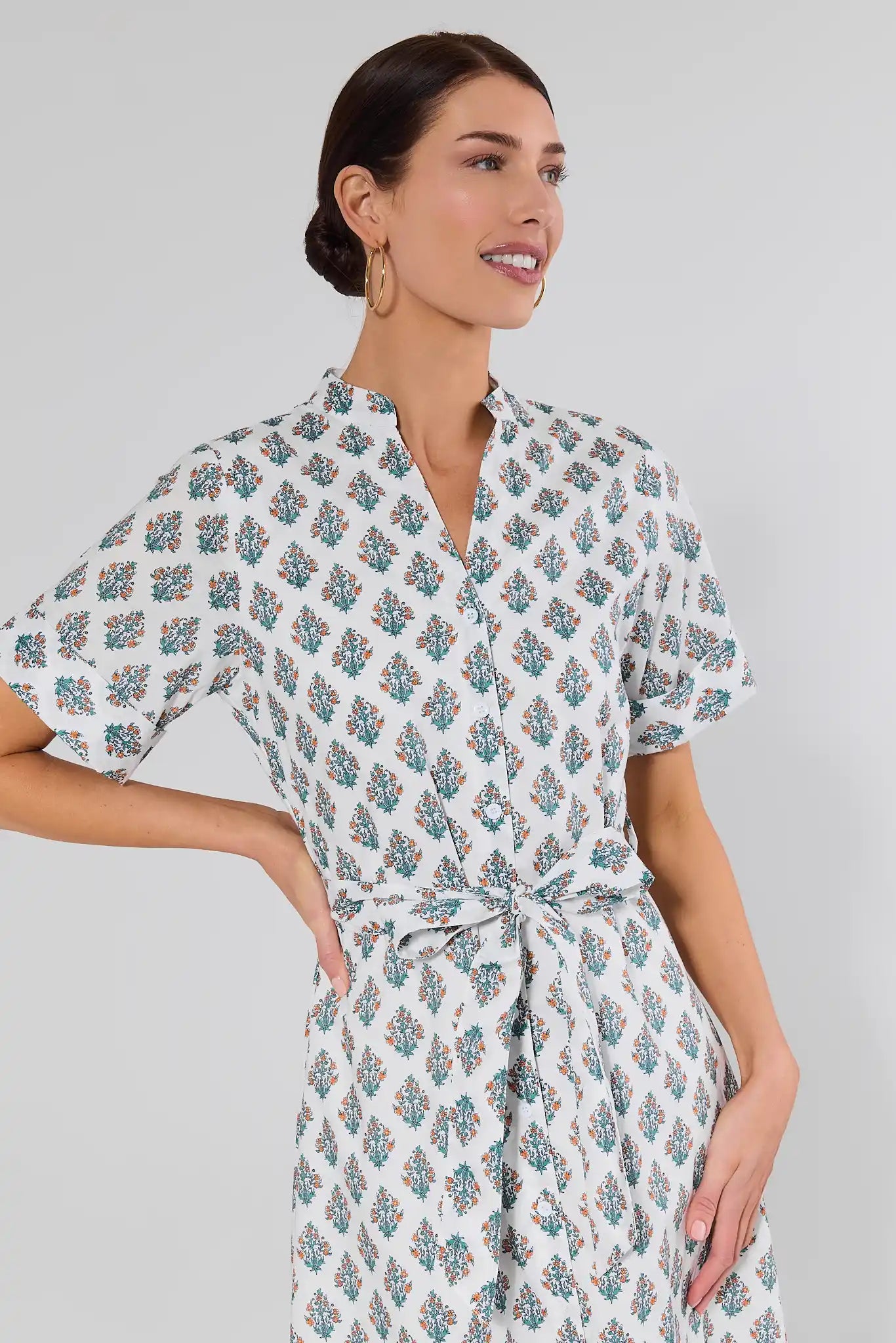 close up woman wearing white dress with floral block print on white background