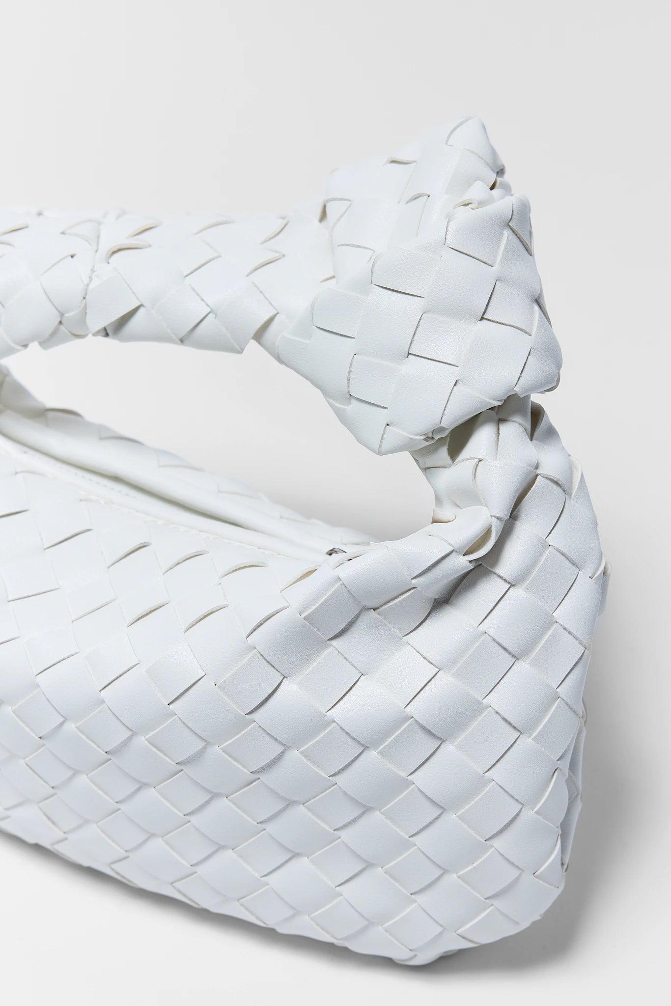 Woven white blanket on a light gray background