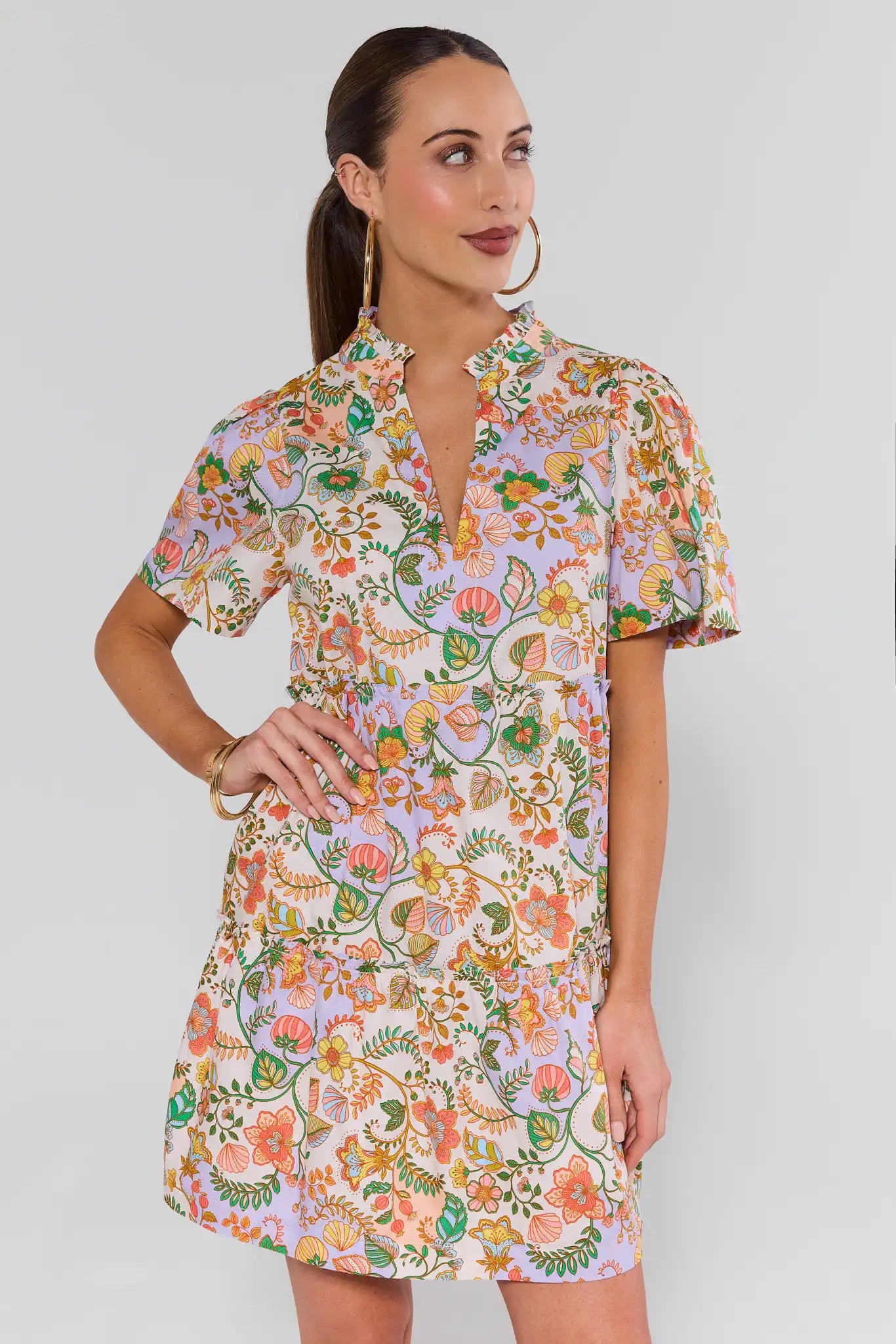 Woman wearing a floral dress against a plain background