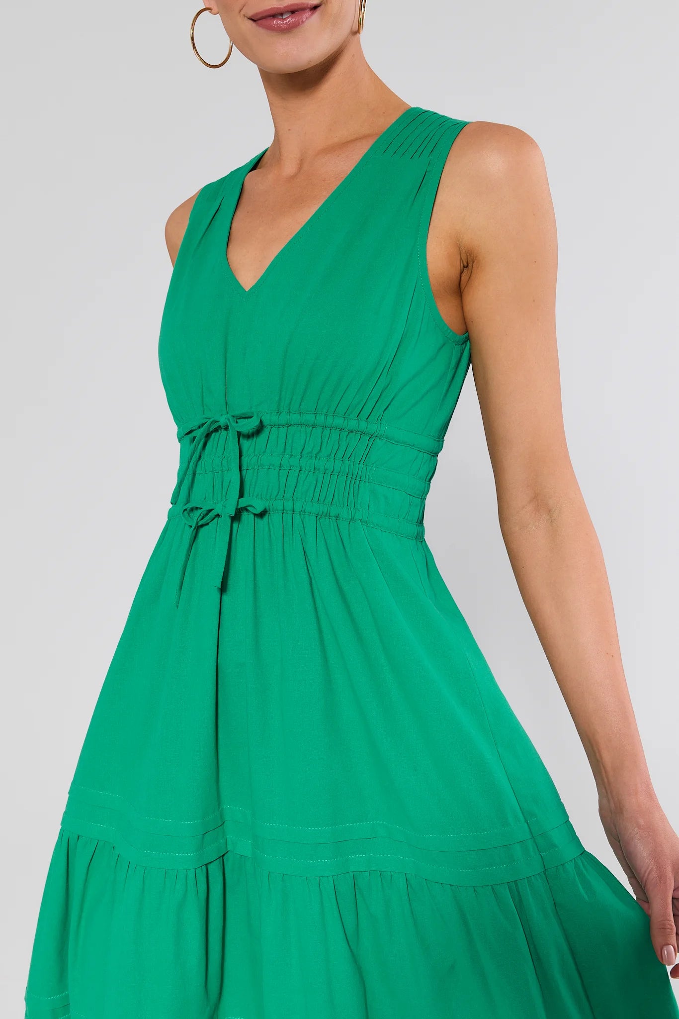 close up Green dress worn by a model on a white background