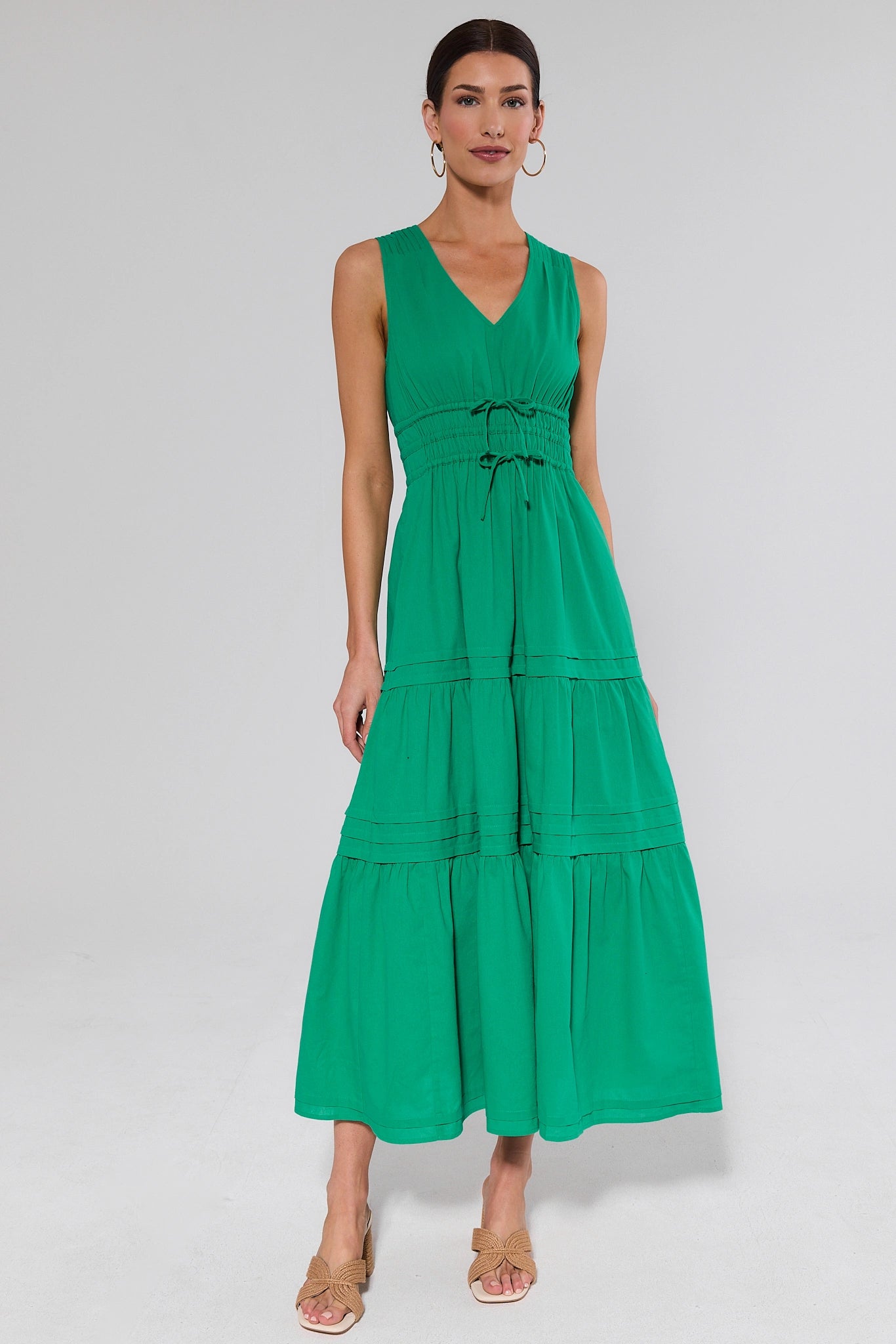 Woman wearing a green gwendolyn dress on a white background